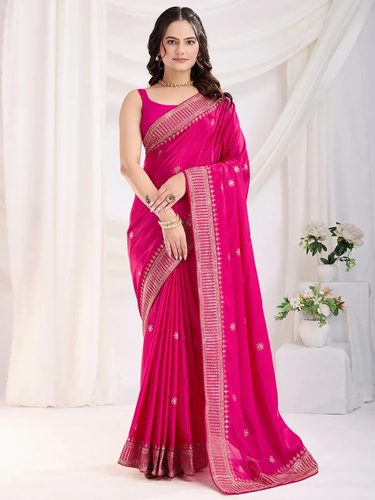 Vibrant pink designer saree with gold embroidery, perfect for Indian ethnic wear occasions