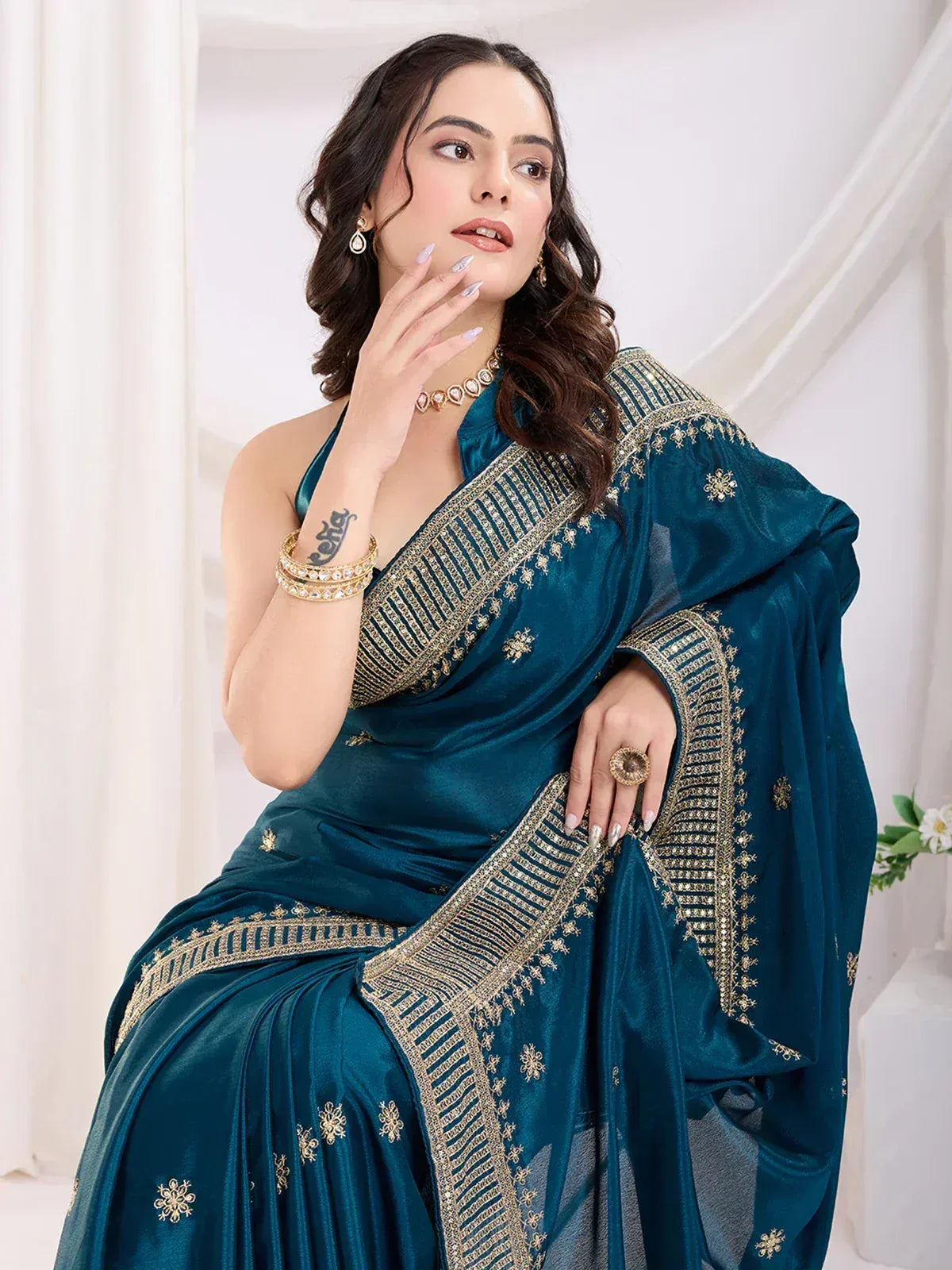 Teal designer saree with gold embroidery, perfect for Indian ethnic wear and festive occasions.
