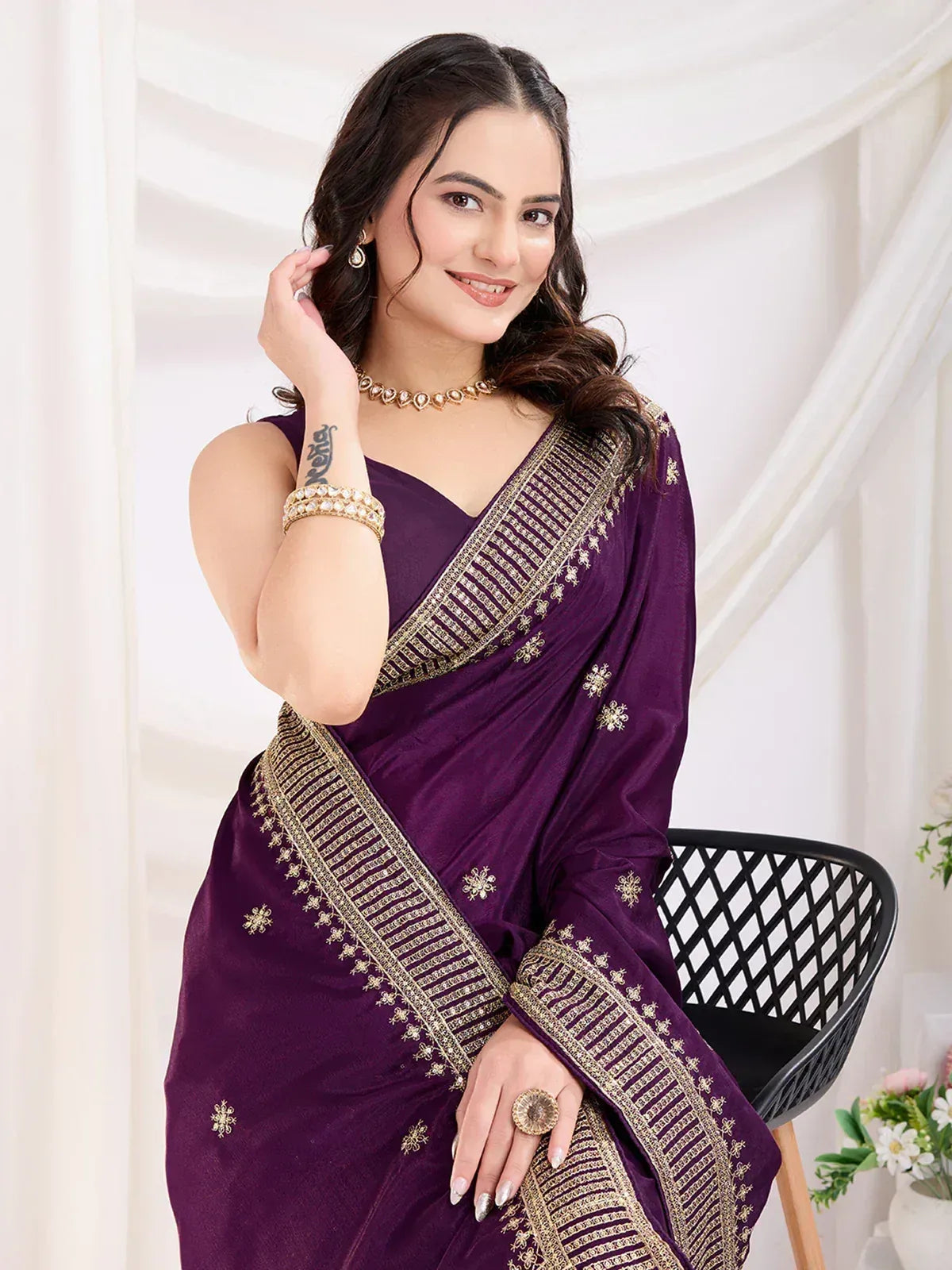 Purple designer saree with gold embroidery, perfect for ethnic occasions and festive wear.