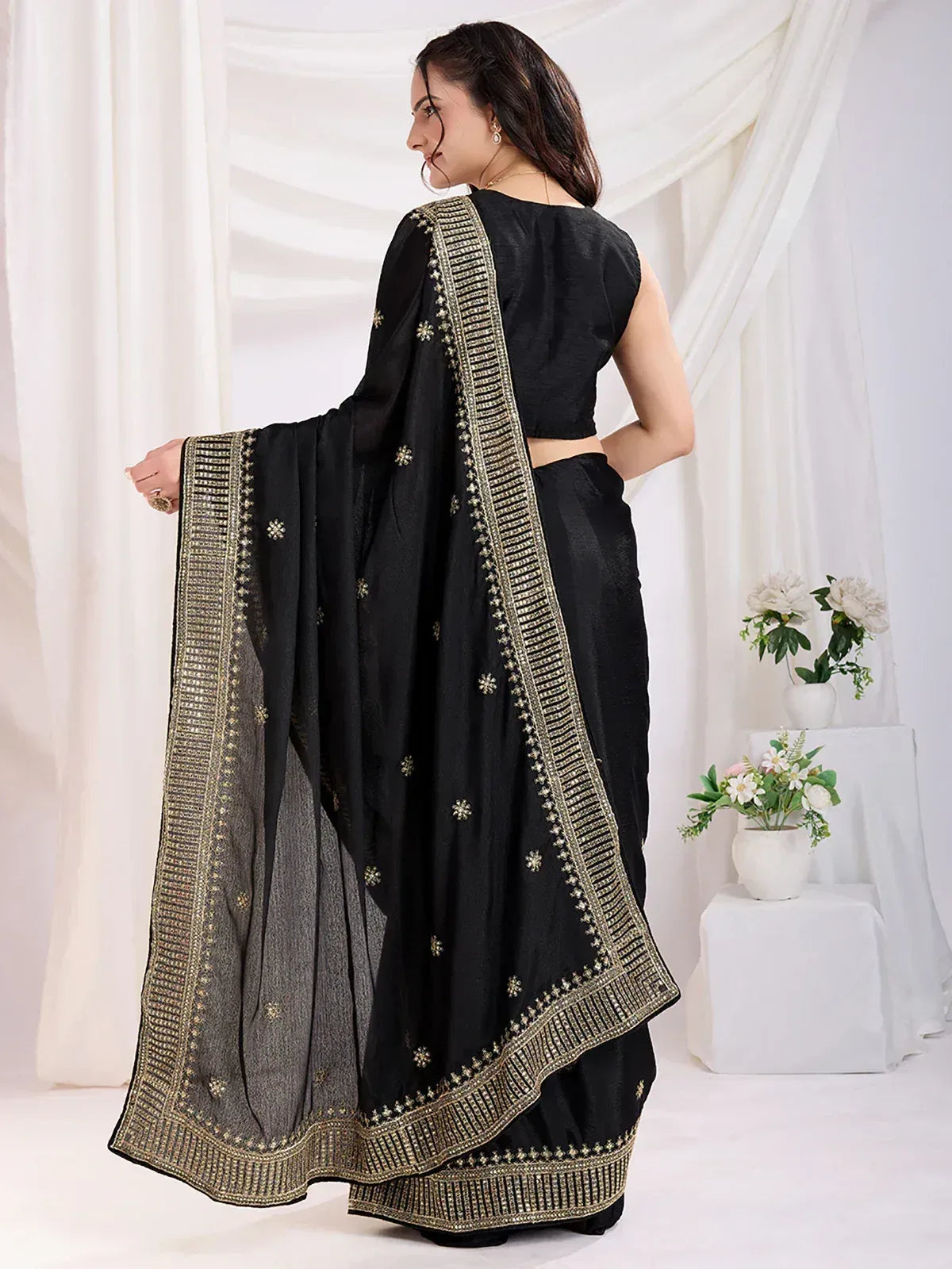 Black saree with gold embroidery and border, paired with matching blouse, elegant ethnic wear