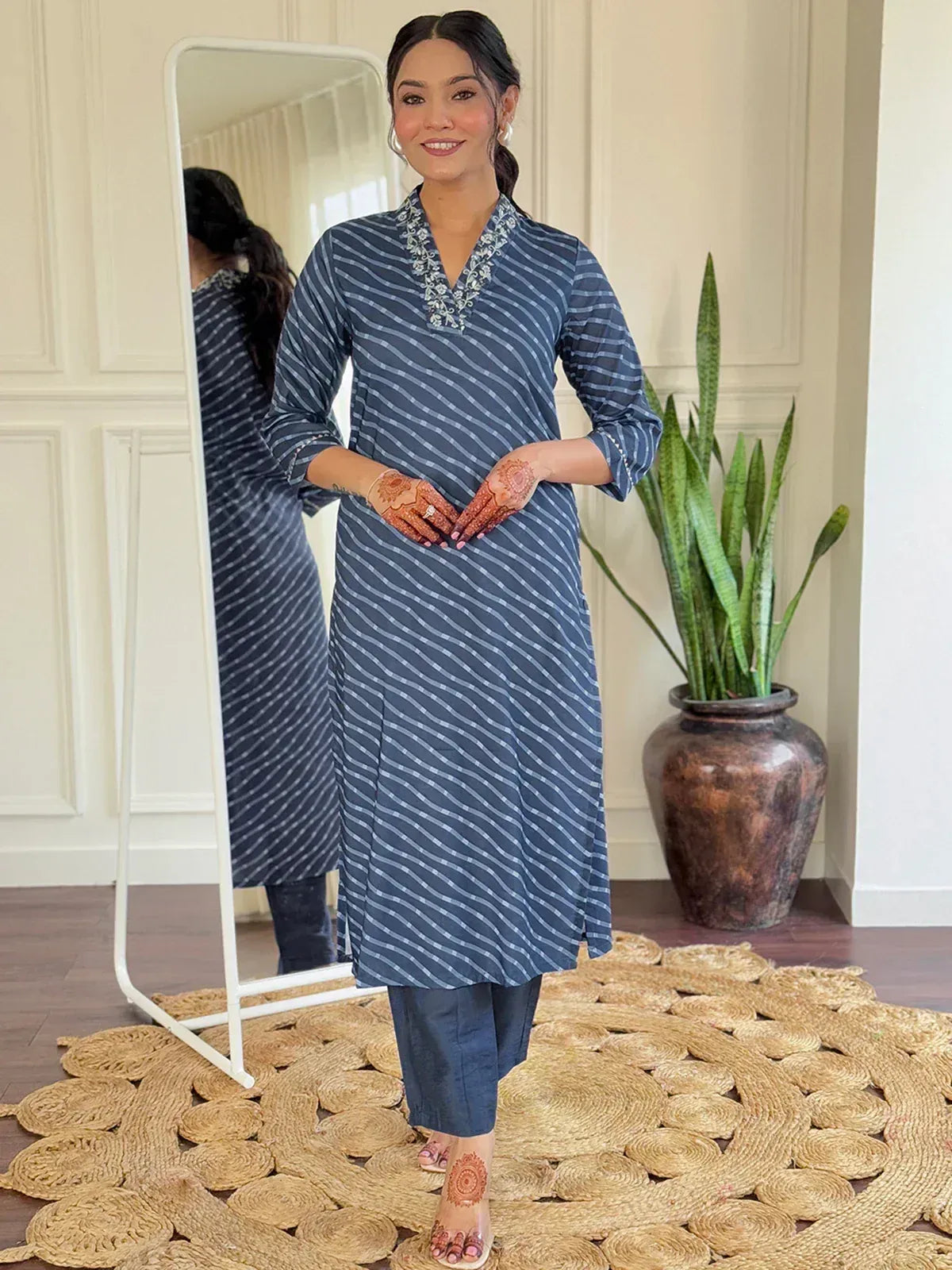 Blue striped kurta with embroidery, paired with matching pants, henna hands, mirror backdrop