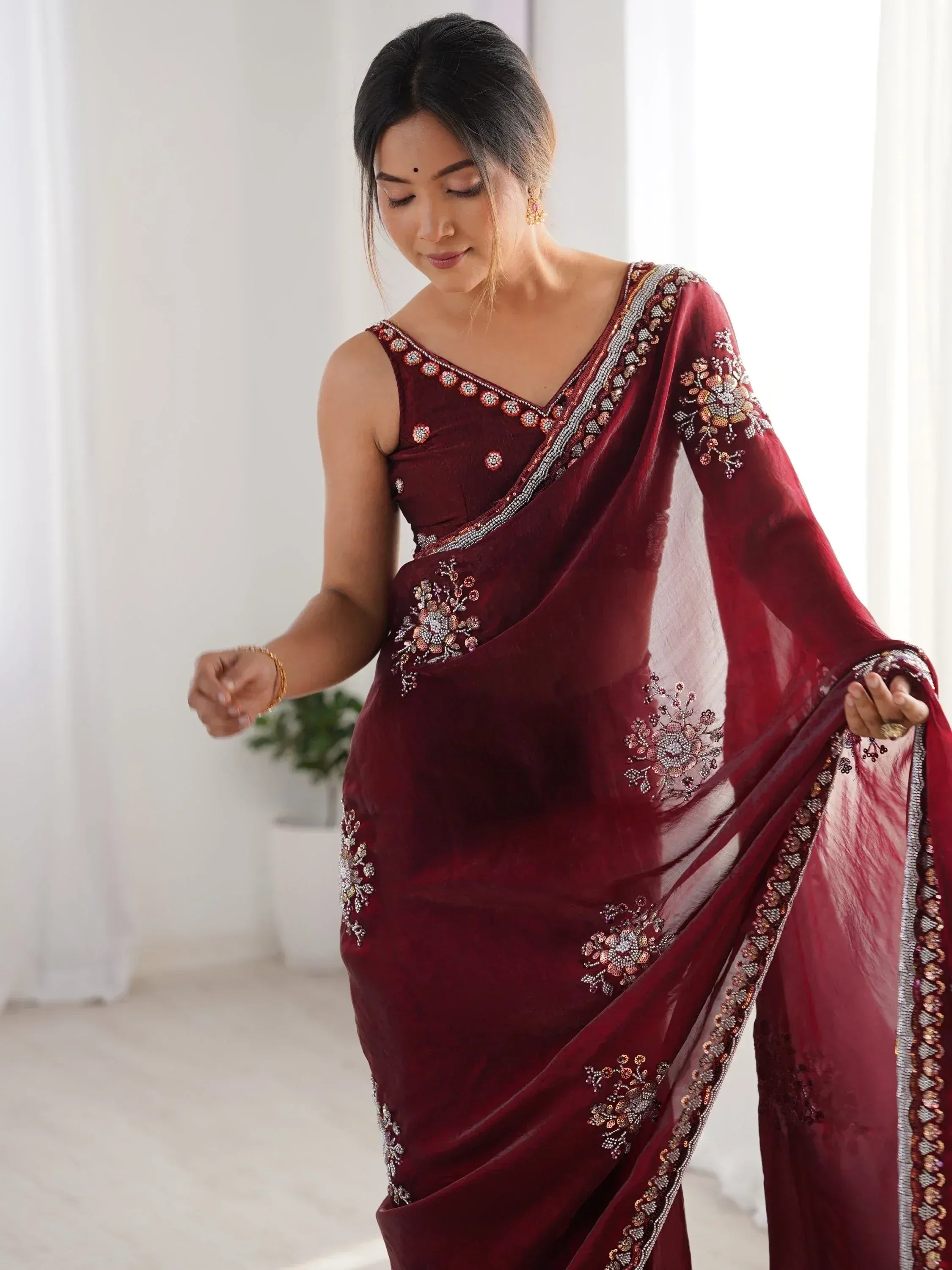Elegant maroon saree with floral embroidery and sequin detailing, perfect for Indian ethnic occasions