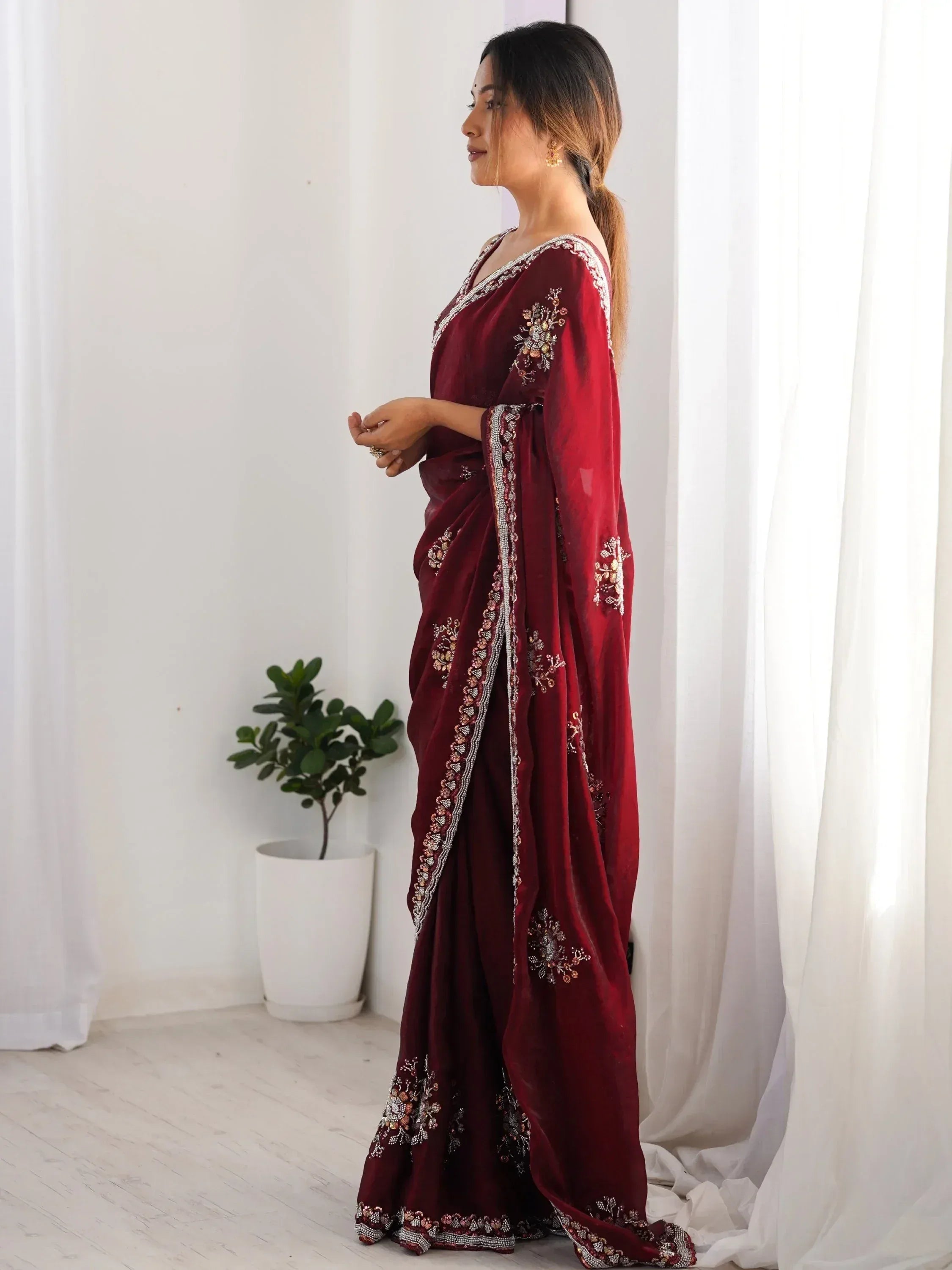 Maroon velvet saree with floral embroidery and sequin border, perfect for Indian ethnic wear occasions