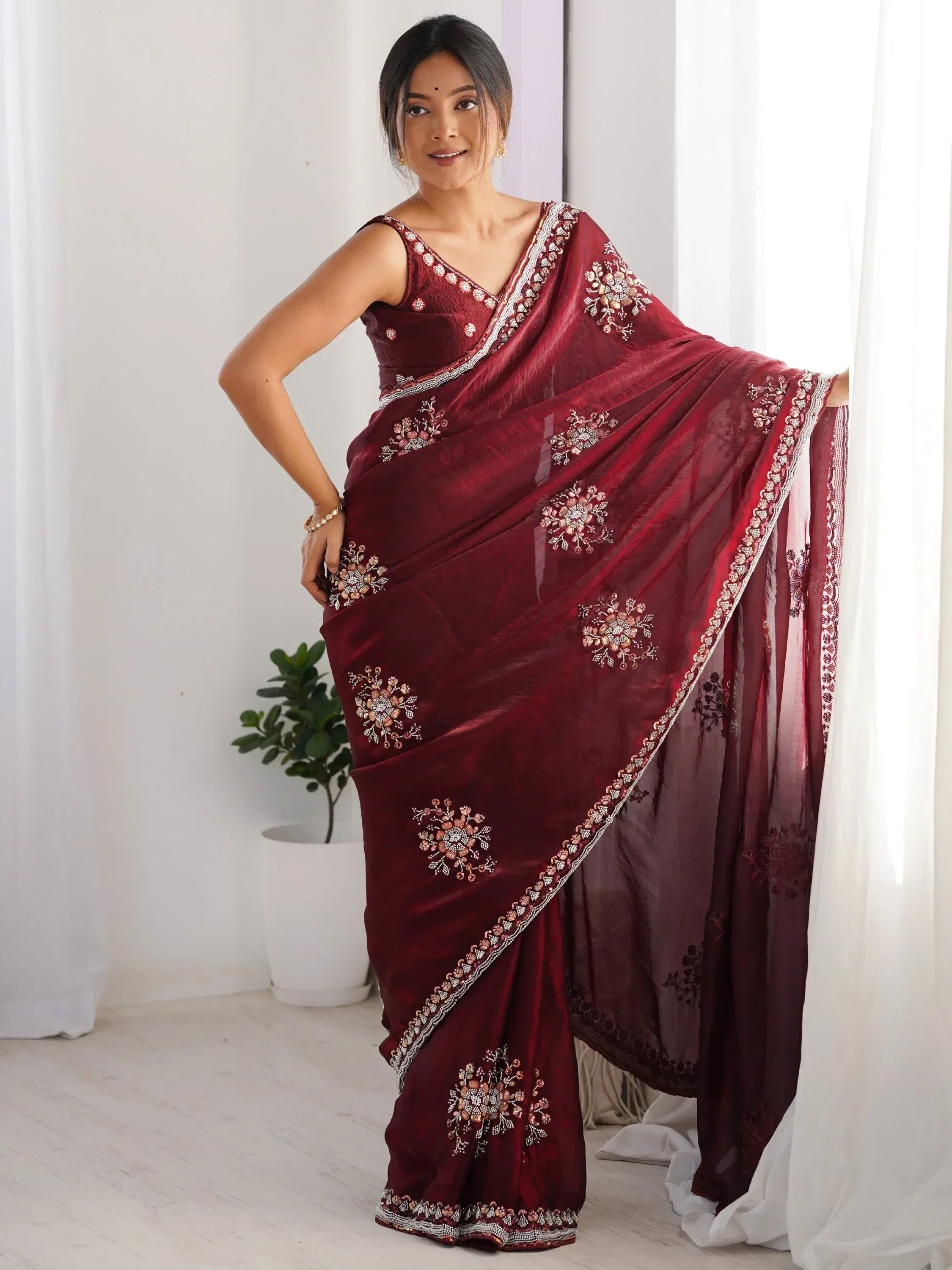 Woman in maroon embroidered saree with floral embellishments, Indian ethnic wear