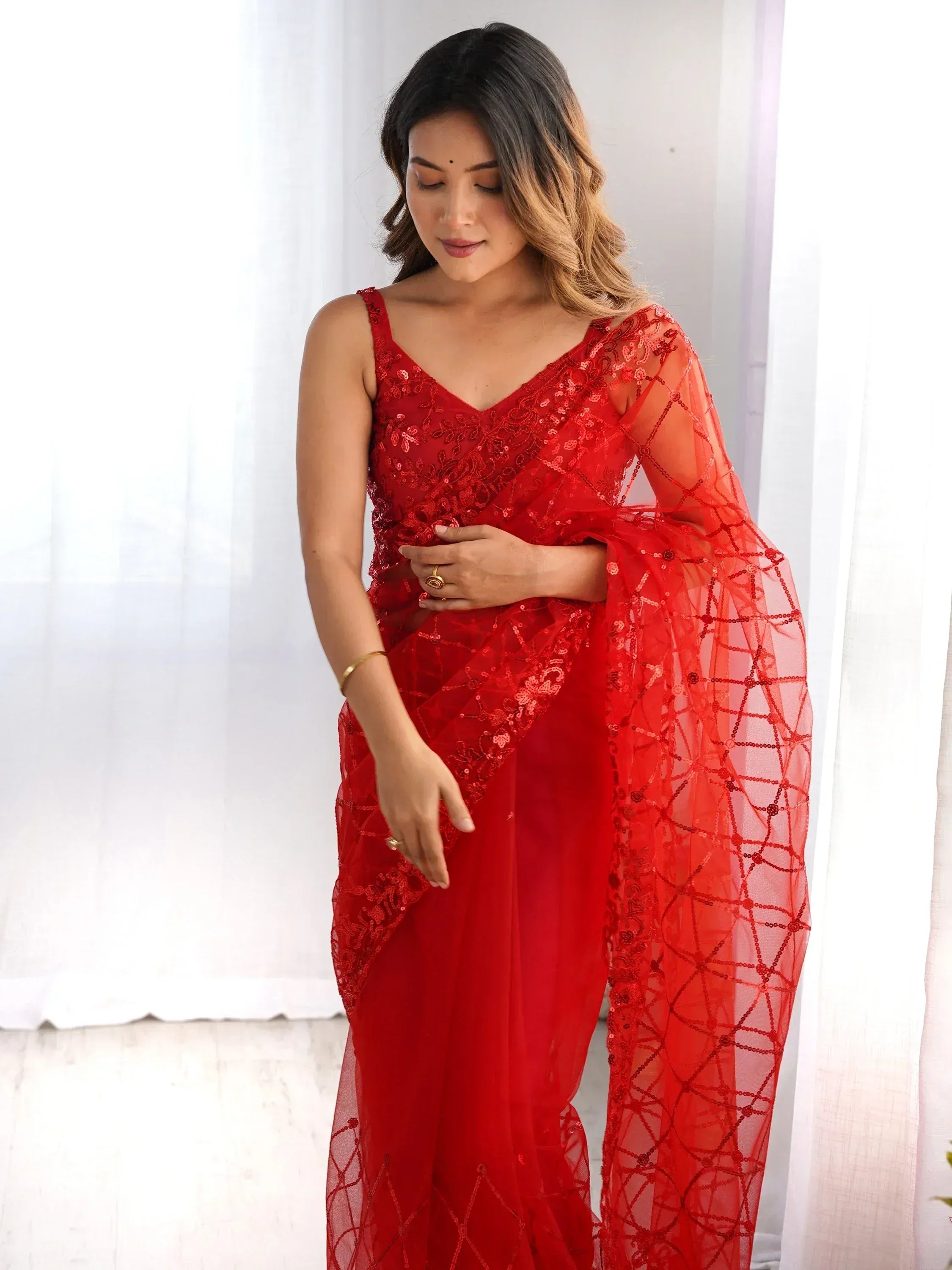 Red sequin saree with sheer net blouse, elegant Indian ethnic wear for weddings and parties