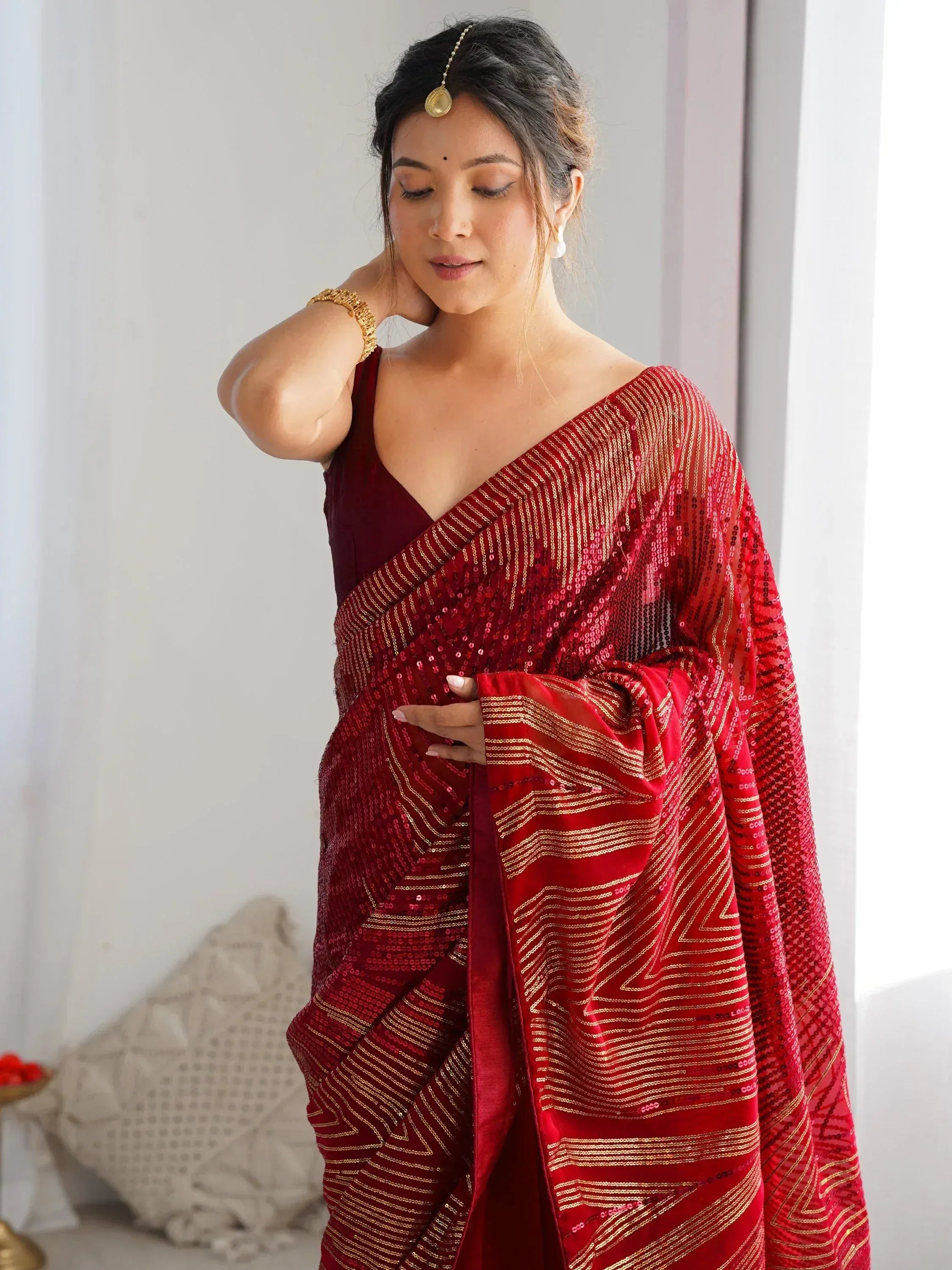 Red sequin saree with gold stripes, paired with velvet blouse, perfect for Indian ethnic occasions
