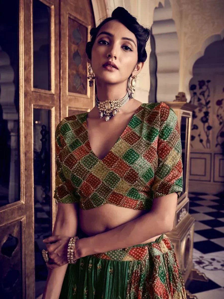 Woman in colorful checkered lehenga choli with gold jewelry, traditional Indian ethnic wear
