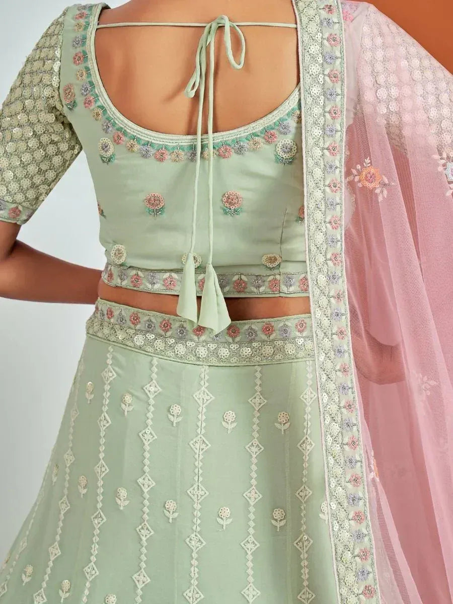 Mint green embroidered lehenga choli with floral motifs and pink dupatta, perfect for Indian ethnic wear.