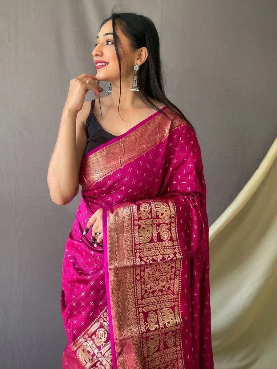 Elegant magenta saree with gold elephant motifs and border, styled with black blouse for ethnic wear
