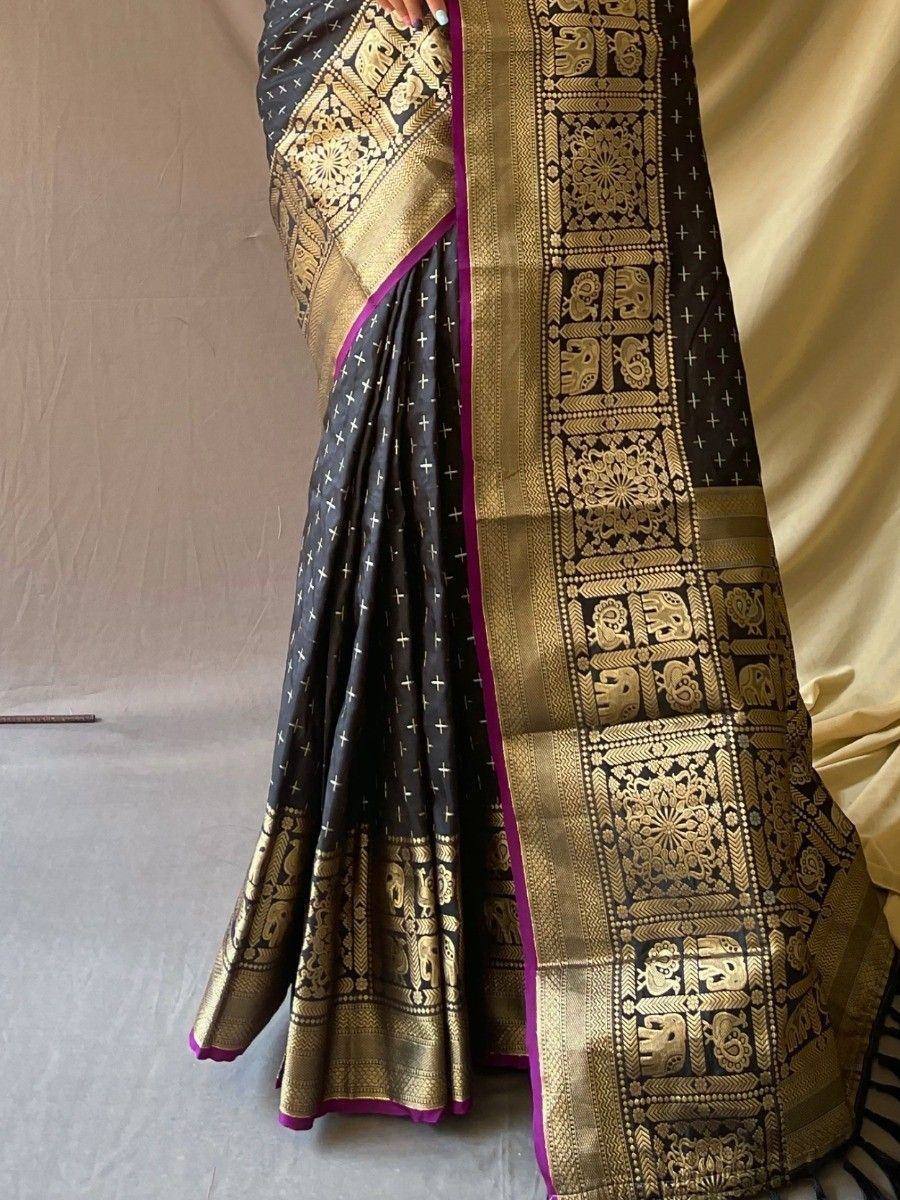 Black and gold ethnic saree with elephant motifs and purple border, perfect for Indian occasions