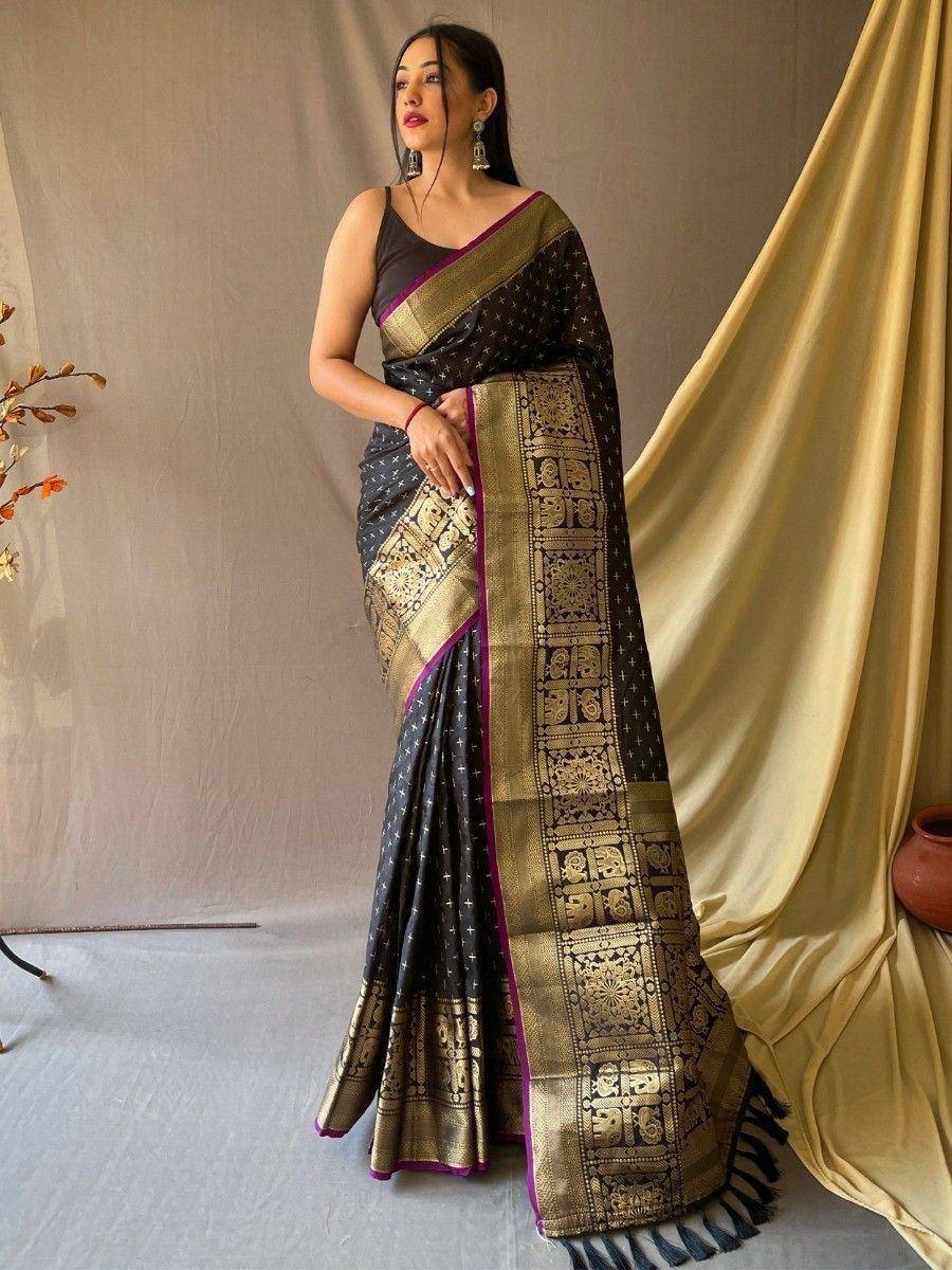 Black and gold designer saree with intricate temple border and purple trim, perfect for ethnic occasions