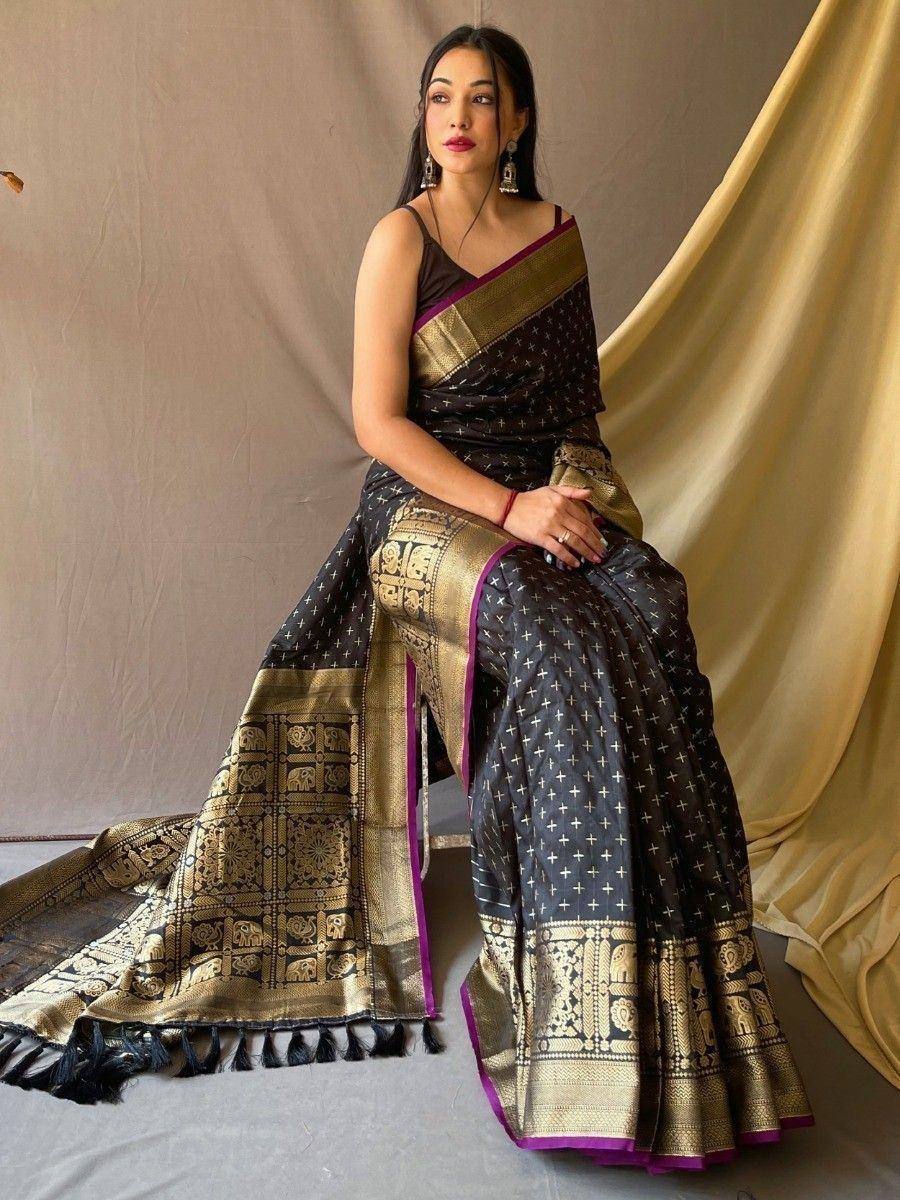 Black and gold ethnic saree with intricate temple border and purple accents, perfect for festive occasions