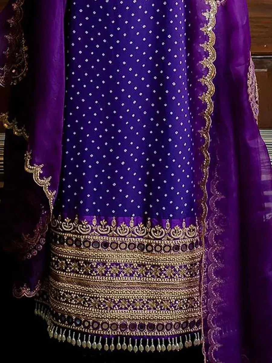 Purple ethnic salwar kameez with gold embroidery and mirror work, perfect for festive occasions.