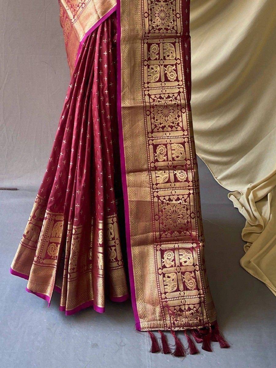 Maroon silk saree with gold elephant motifs and zari border, perfect for Indian ethnic wear