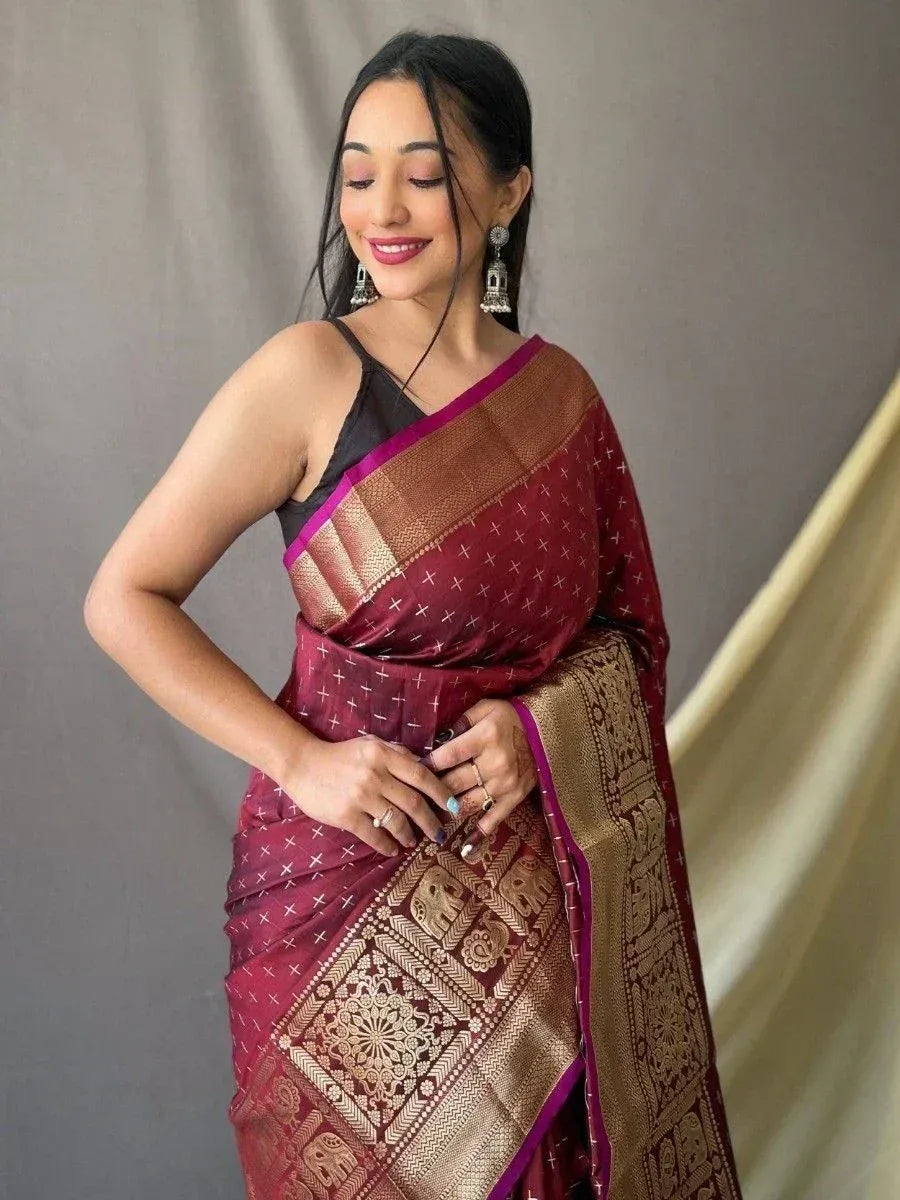 Elegant maroon saree with gold elephant motifs and purple border, paired with black blouse for Indian ethnic wear