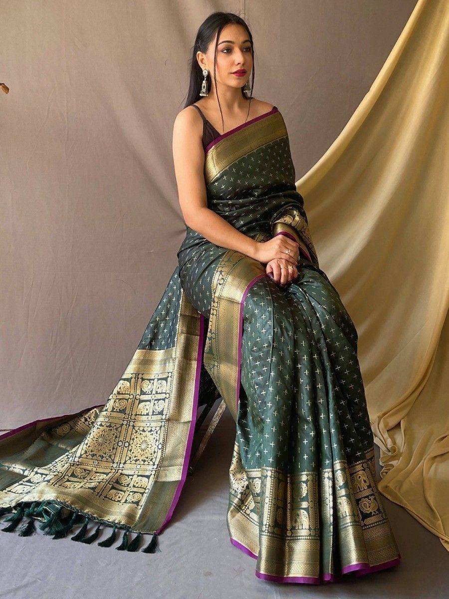 Elegant green saree with gold elephant motifs and purple border, perfect for Indian ethnic occasions