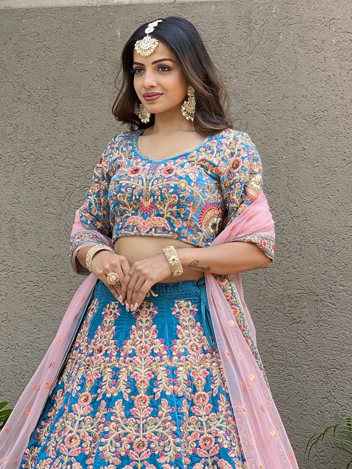 Blue floral embroidered lehenga choli with pink dupatta, perfect for Indian weddings and festive occasions.