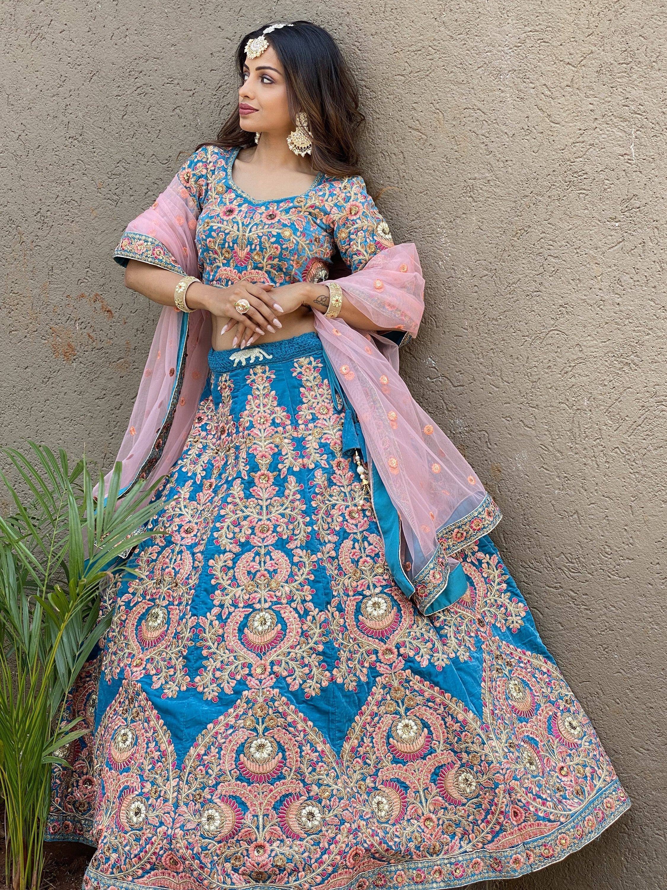 Blue and pink embroidered lehenga choli with floral design, perfect for Indian weddings and festive occasions.