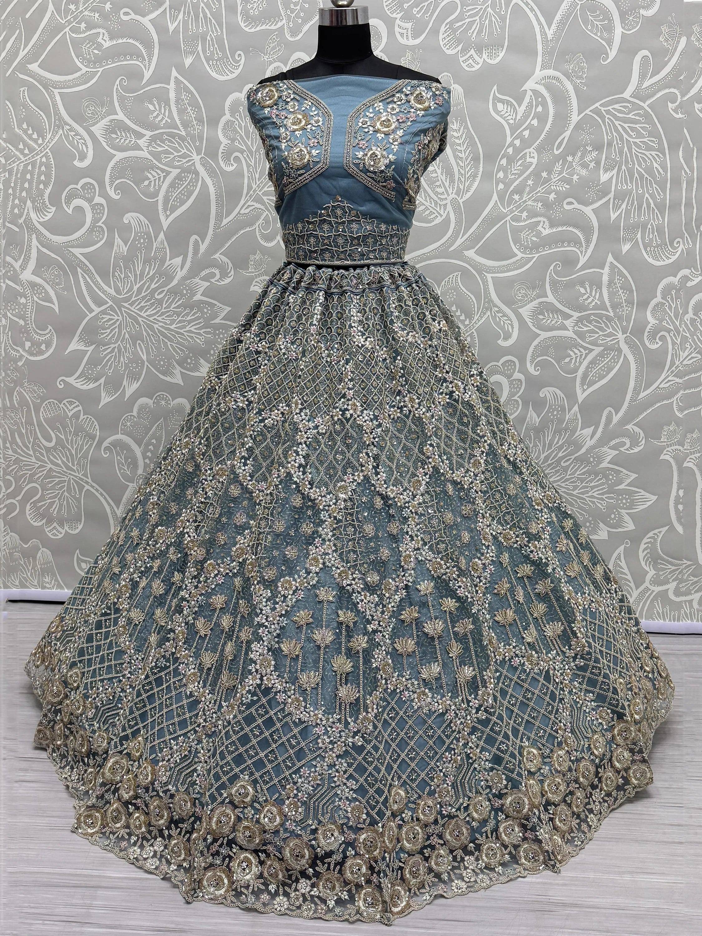 Dusty blue designer lehenga choli with heavy gold floral embroidery and net skirt, perfect for weddings.