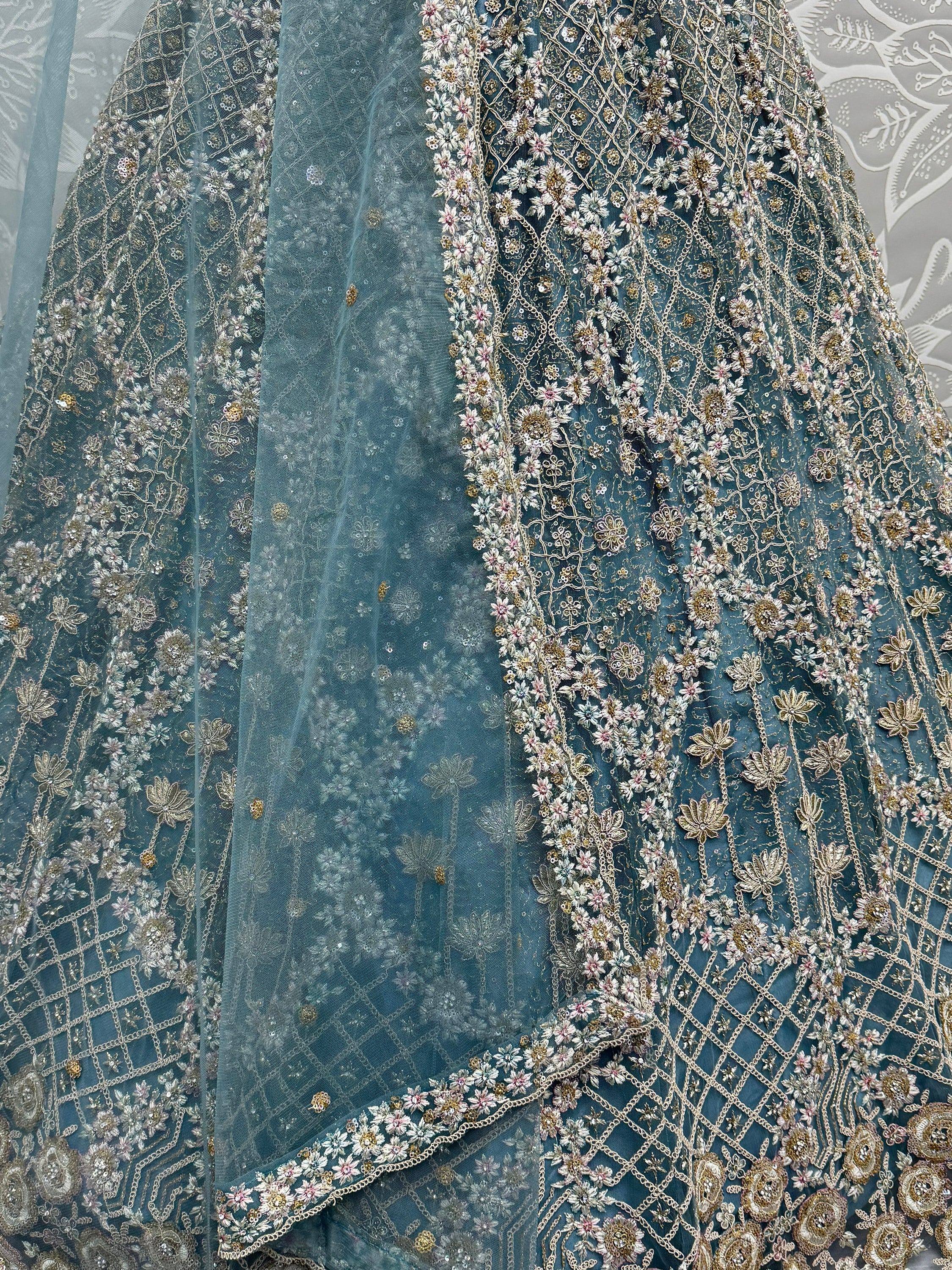 Teal designer lehenga with intricate floral embroidery and gold thread work, perfect for Indian ethnic wear.