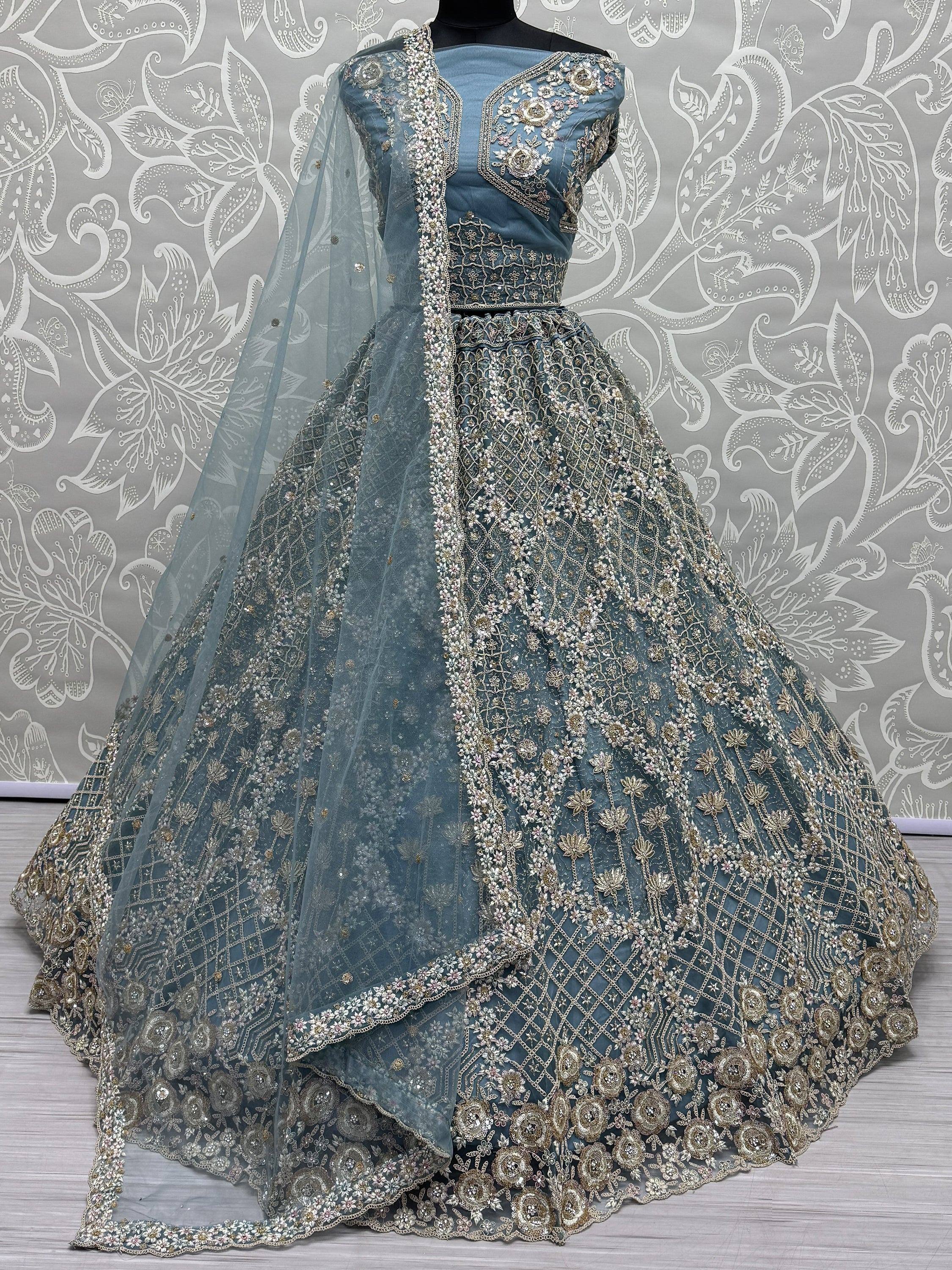 Dusty blue designer lehenga choli with heavy gold embroidery and floral motifs, perfect for weddings