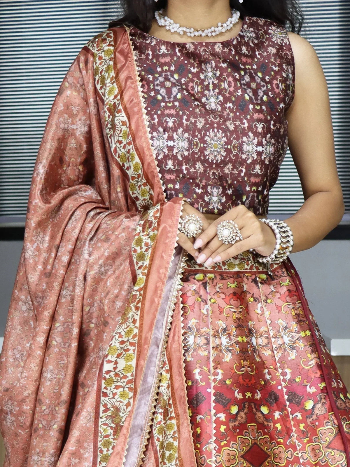 Indian ethnic wear with floral print lehenga choli and matching dupatta, styled with pearl jewelry
