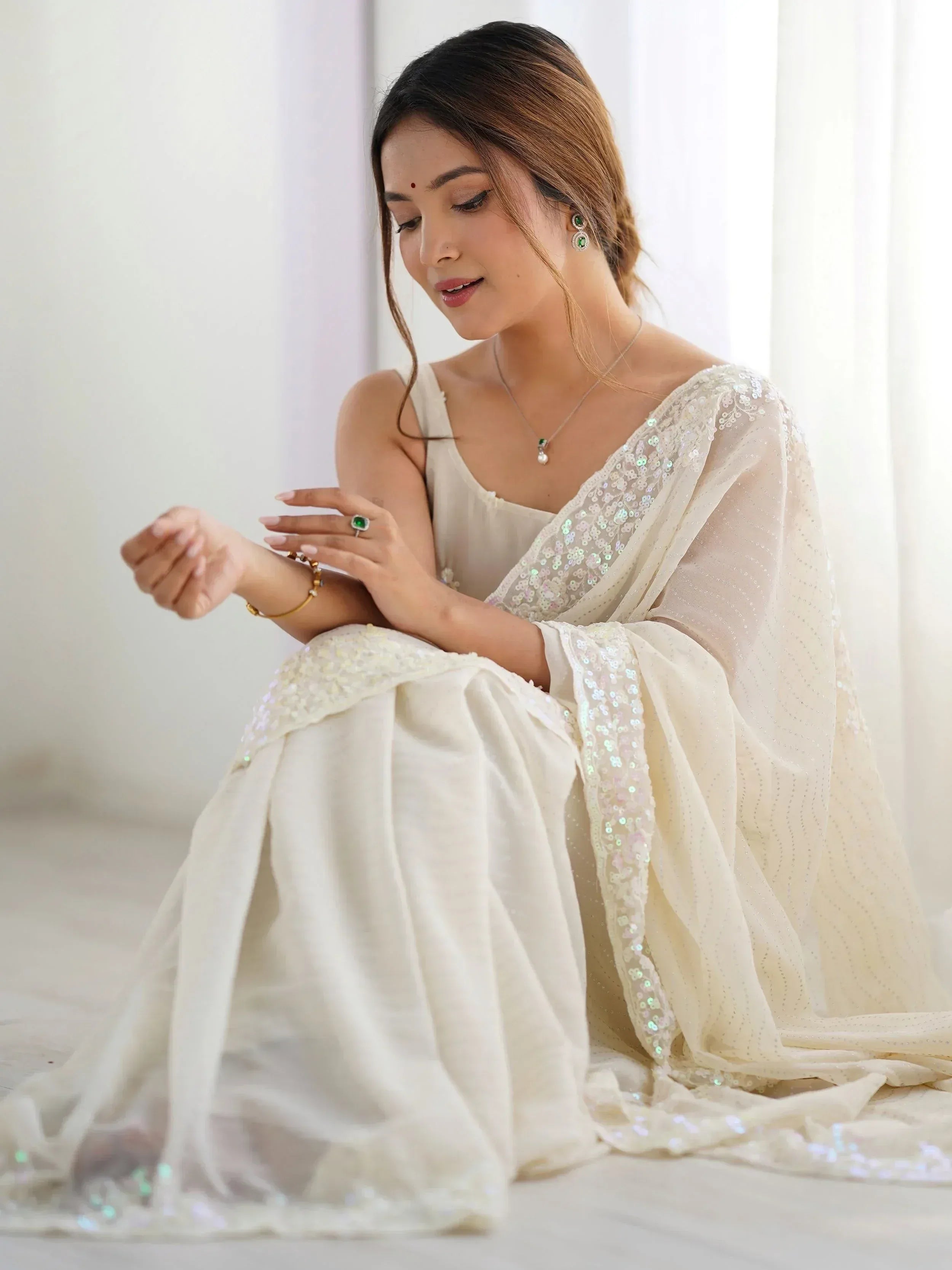 Elegant white ethnic gown with sequin detailing, perfect for Indian weddings or festive occasions.