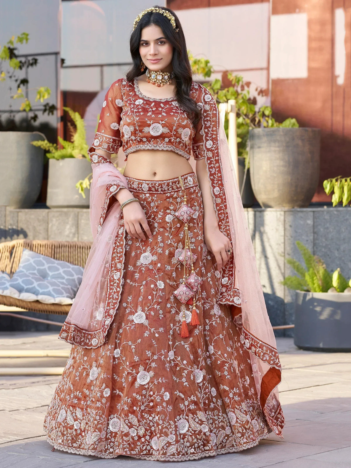 Rust embroidered lehenga choli with floral motifs and pink dupatta, perfect for Indian ethnic occasions