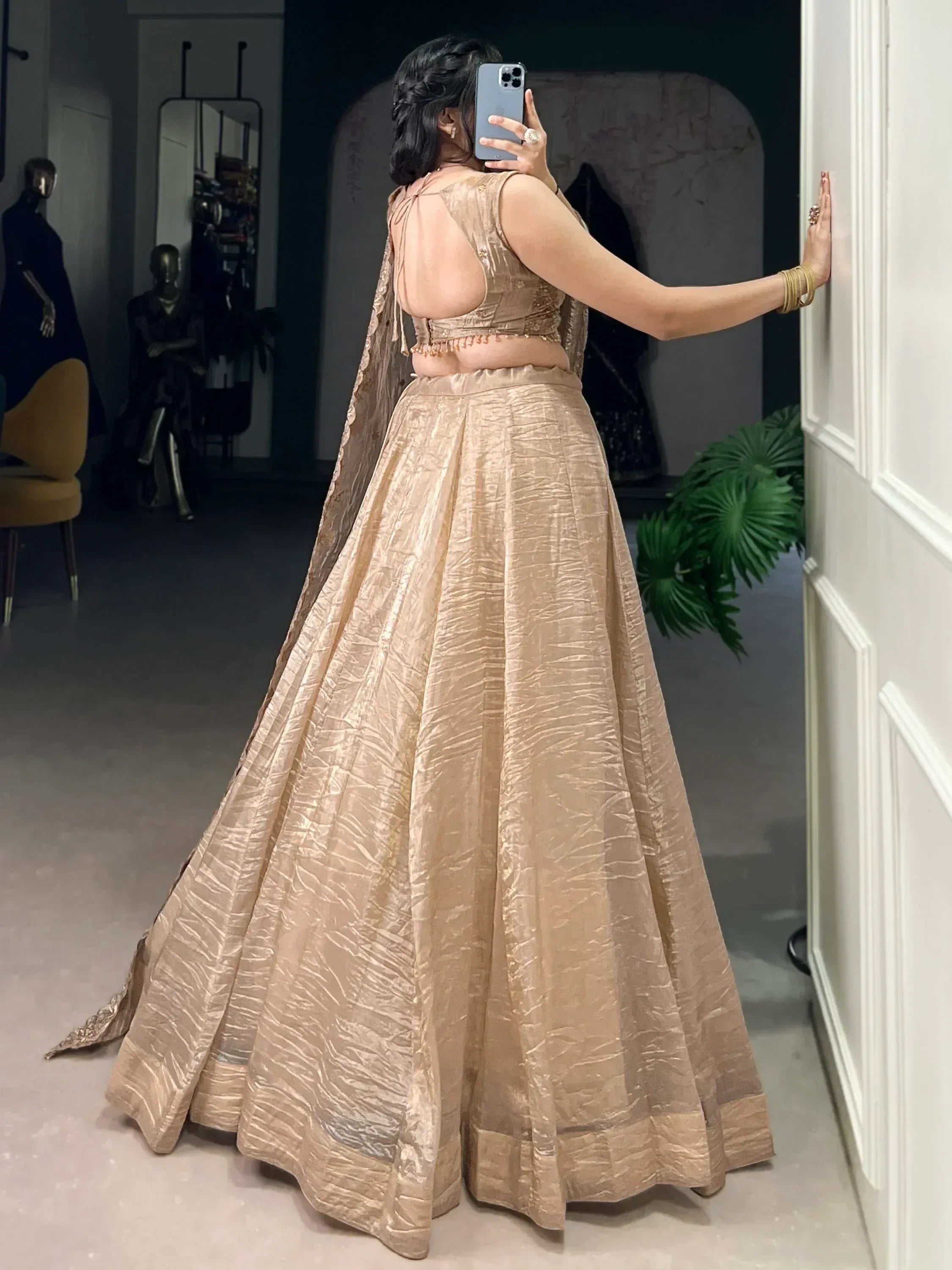 Elegant gold lehenga choli with open back blouse, perfect for Indian weddings and festive occasions.
