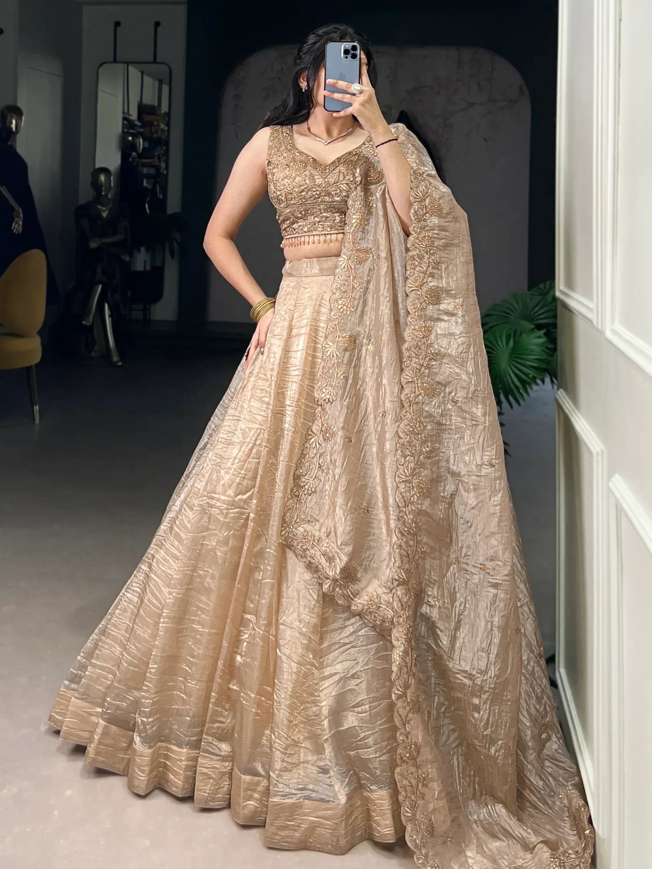 Elegant gold embroidered lehenga choli with floral dupatta, perfect for Indian weddings and festive occasions.