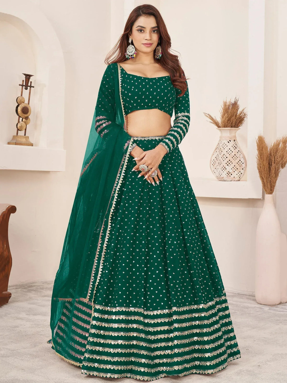 Emerald green designer lehenga choli with sequin work and gold trim, perfect for Indian weddings and festive occasions.