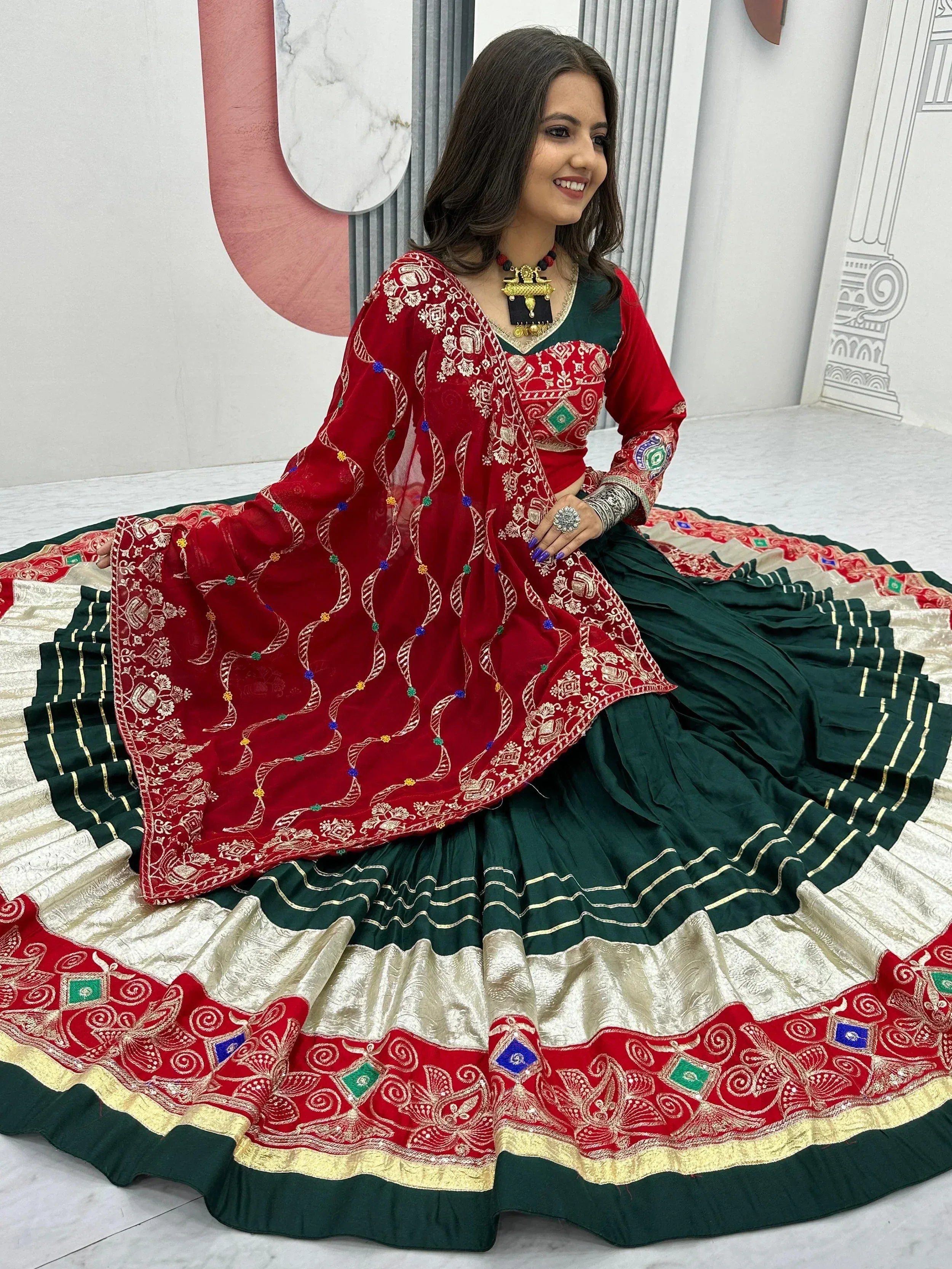 Red and green embroidered lehenga choli with gold detailing, perfect for Indian ethnic wear occasions