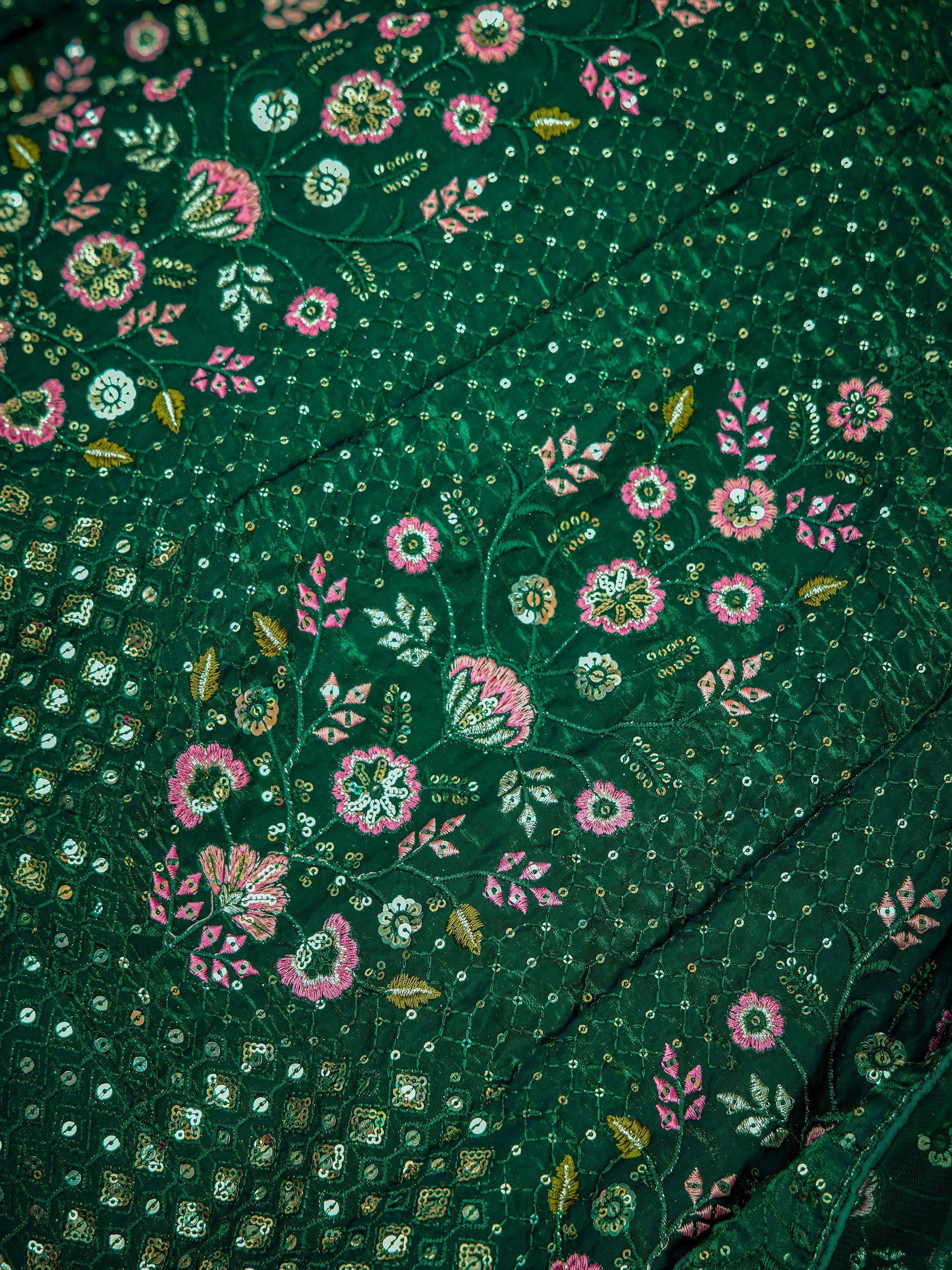 Emerald green ethnic fabric with pink floral embroidery and gold sequins, perfect for designer lehenga or saree.