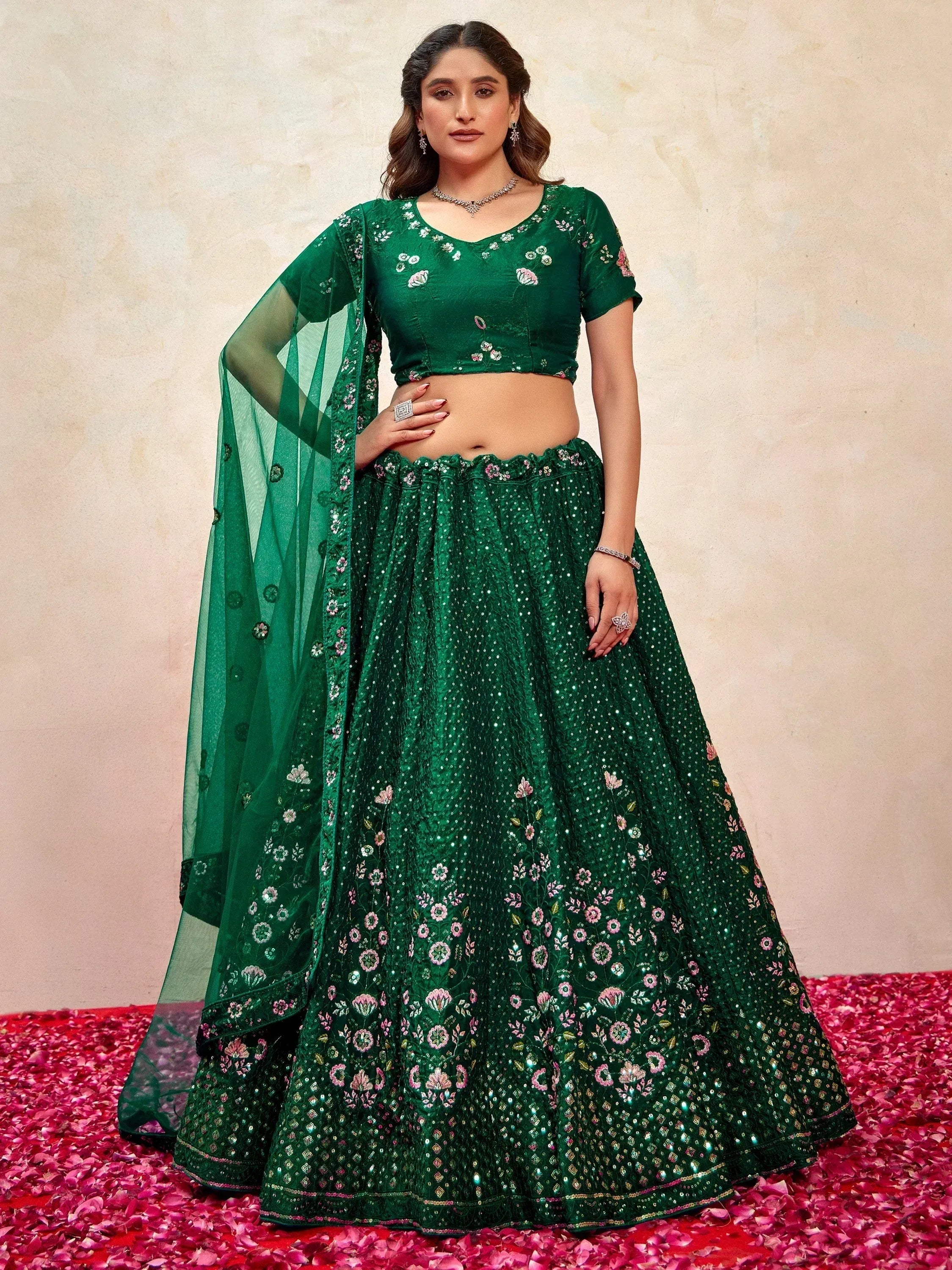 Emerald green embroidered lehenga choli with floral motifs and sheer dupatta, perfect for Indian ethnic occasions