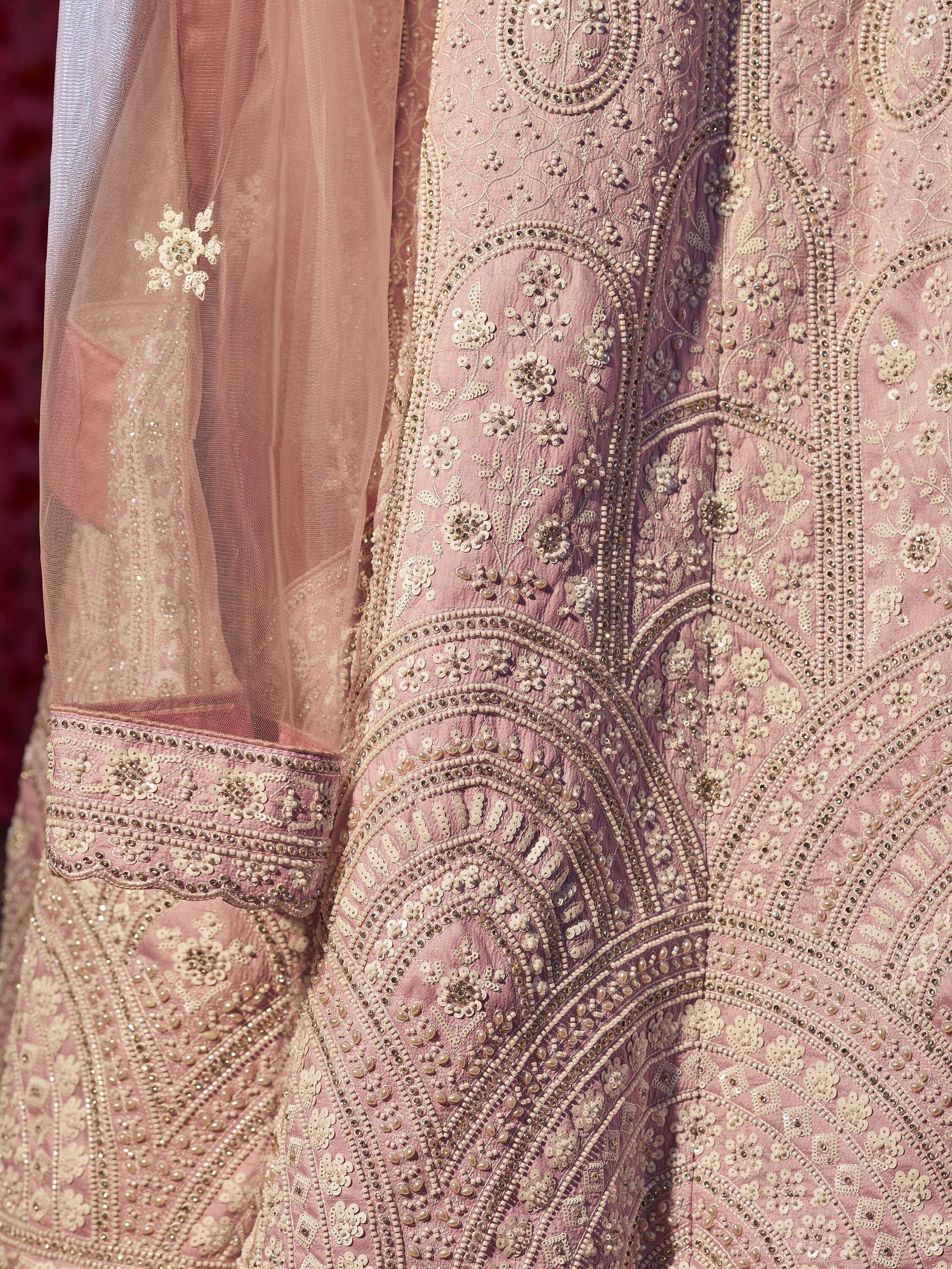 Pink embroidered lehenga choli with intricate beadwork and floral motifs, perfect for Indian ethnic wear.