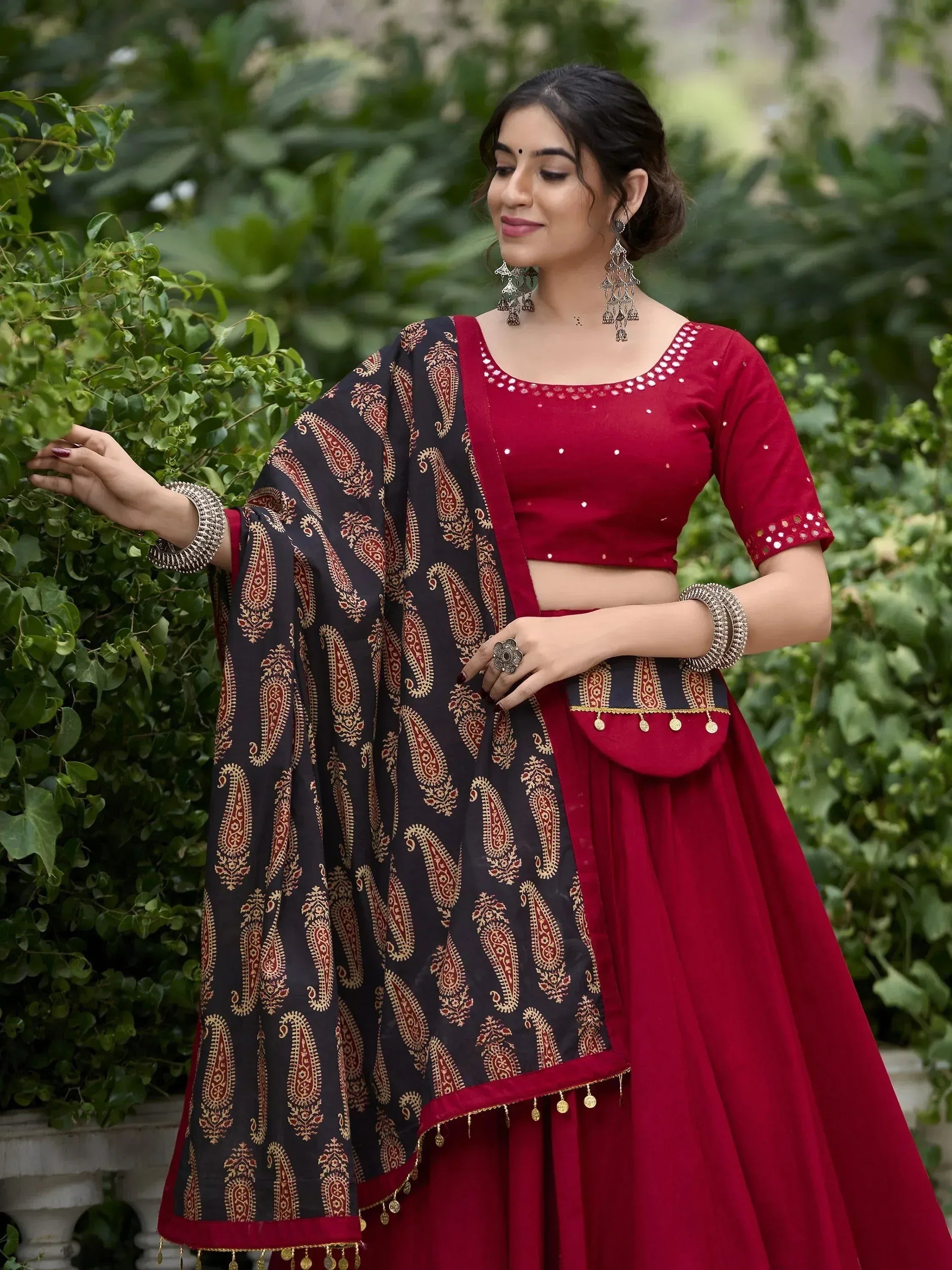 Red and black printed lehenga choli with mirror work, perfect for Indian ethnic wear occasions.