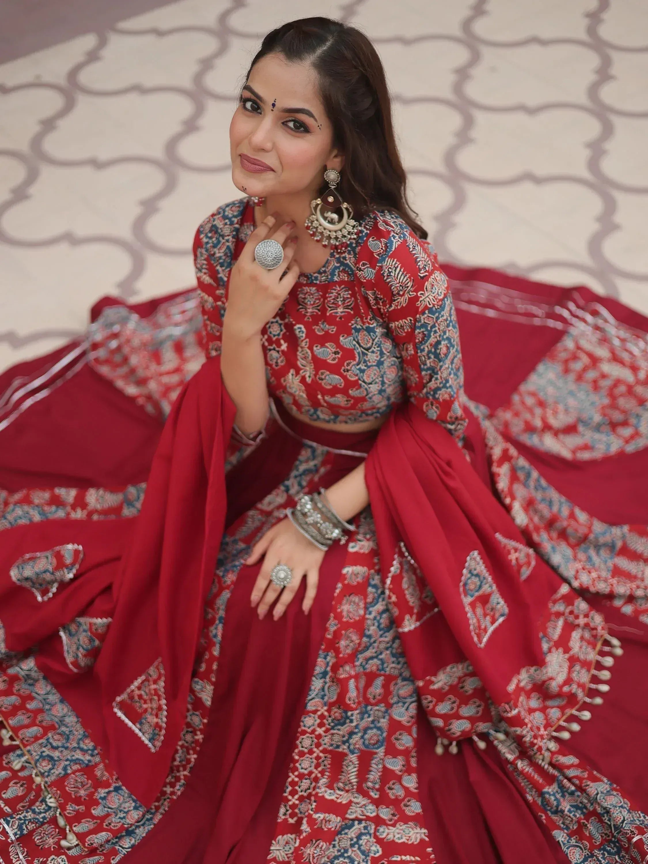 Red and blue printed lehenga choli with traditional jewelry for Indian ethnic wear