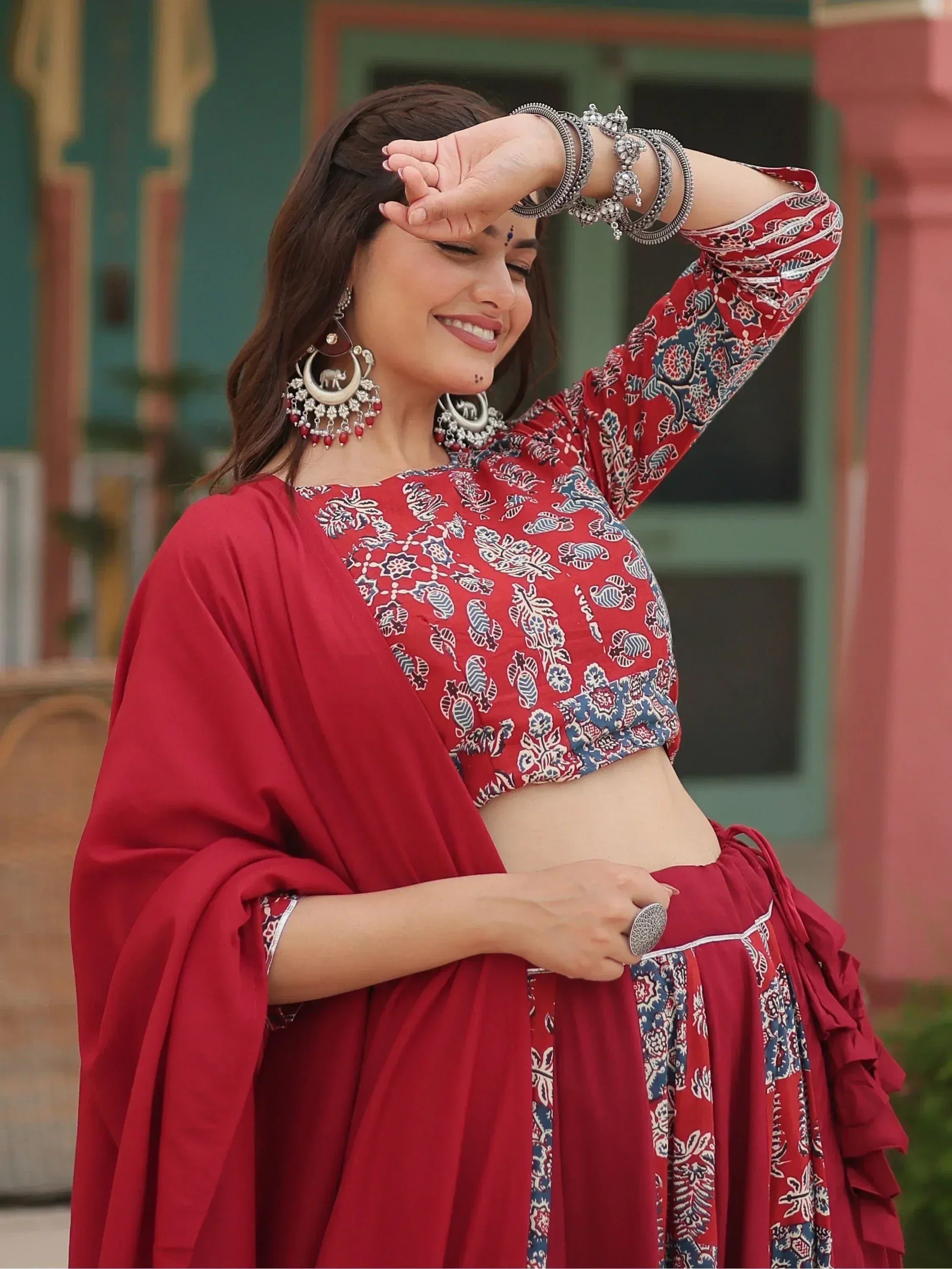 Woman in red printed lehenga choli with silver jewelry, traditional Indian ethnic wear