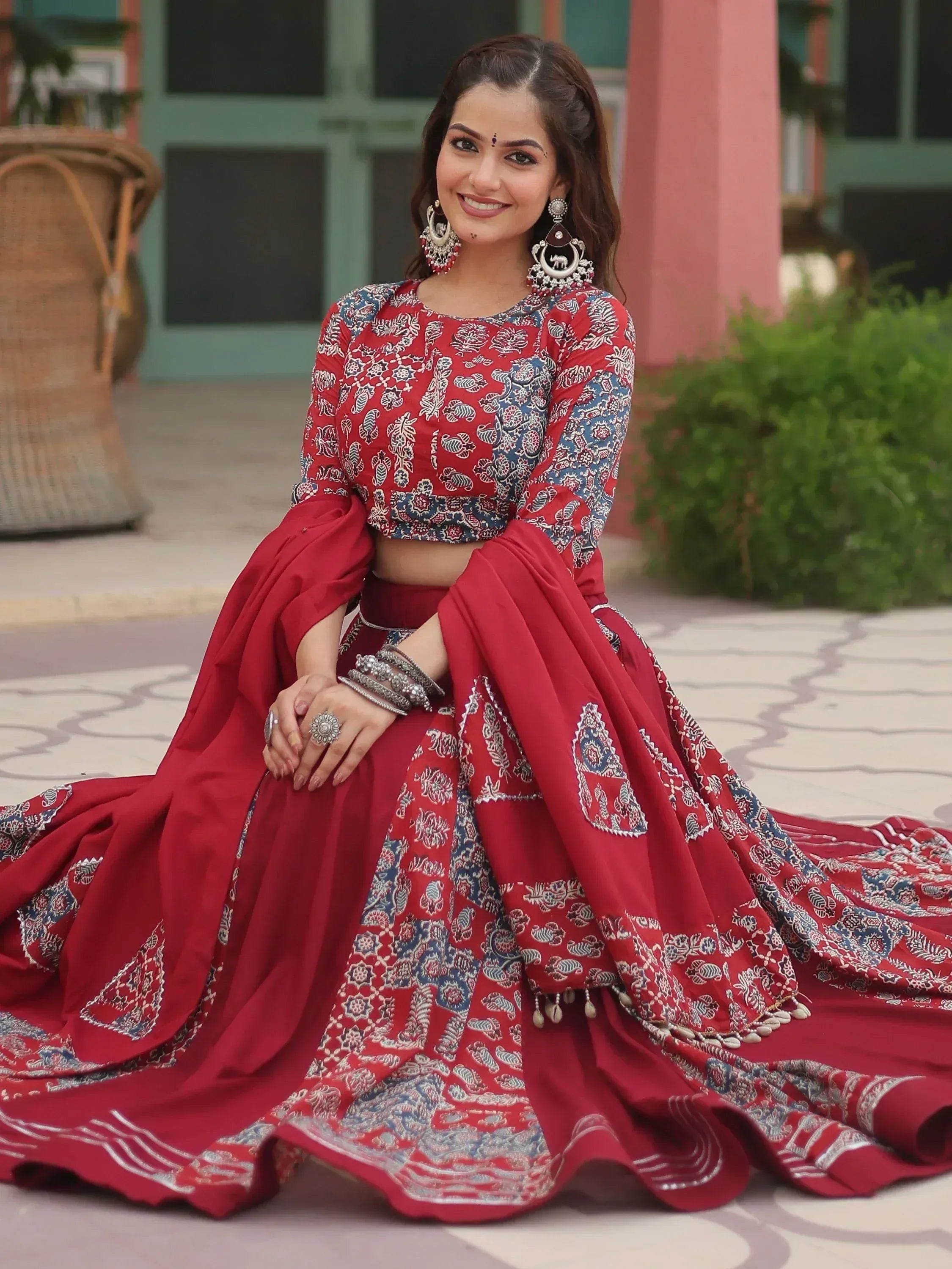 Red and blue printed lehenga choli with floral patterns, perfect for Indian ethnic wear occasions