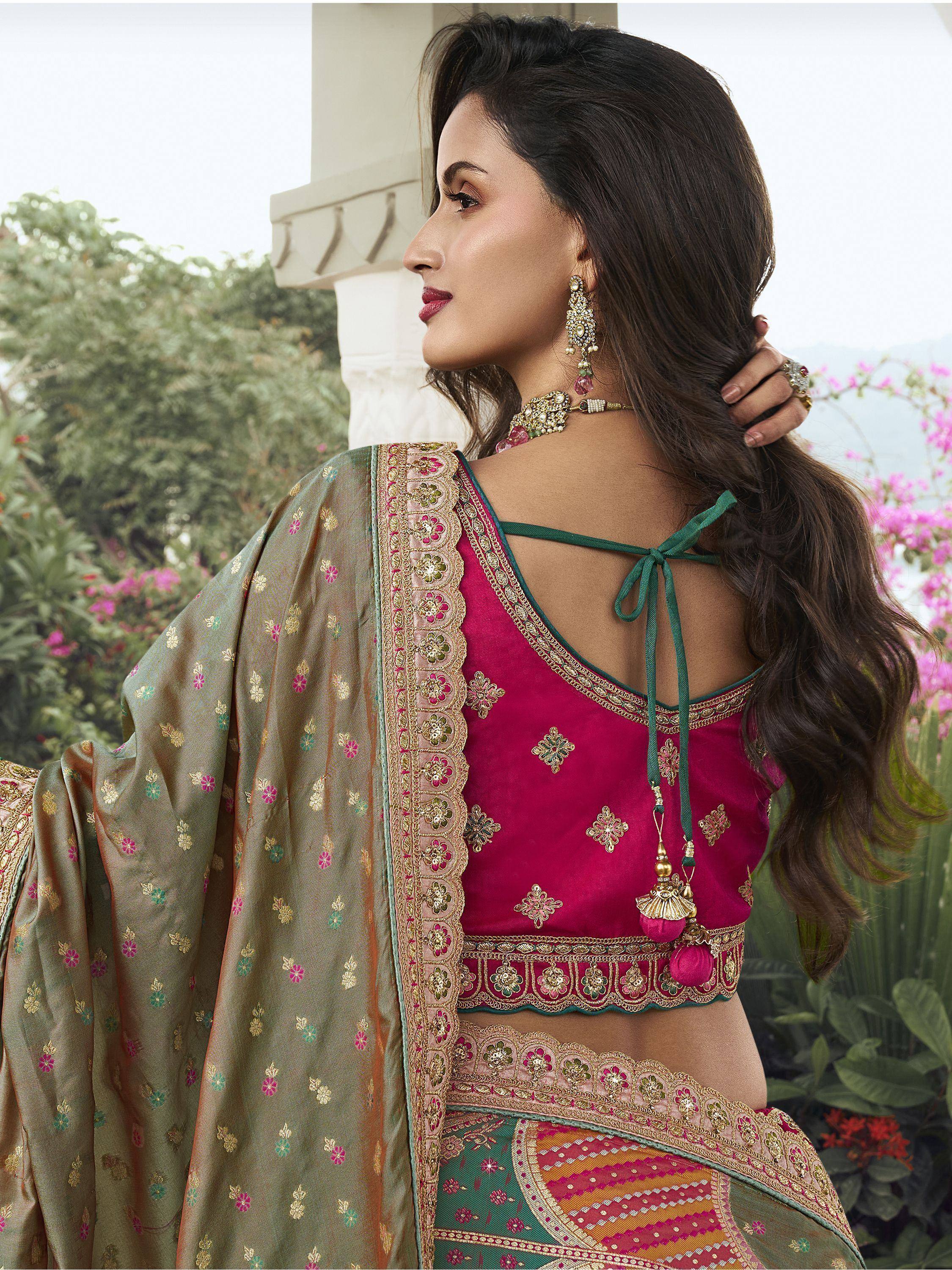 Elegant Indian ethnic wear with embroidered pink blouse, floral dupatta, and traditional jewelry for festive occasions