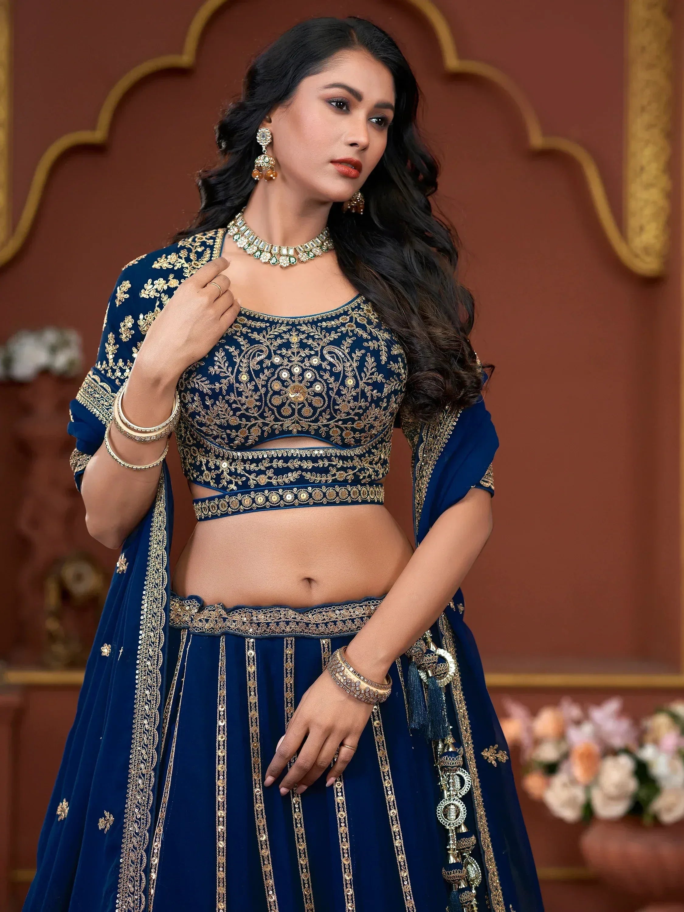 Royal blue embroidered lehenga choli with gold detailing, perfect for Indian weddings and festive occasions.