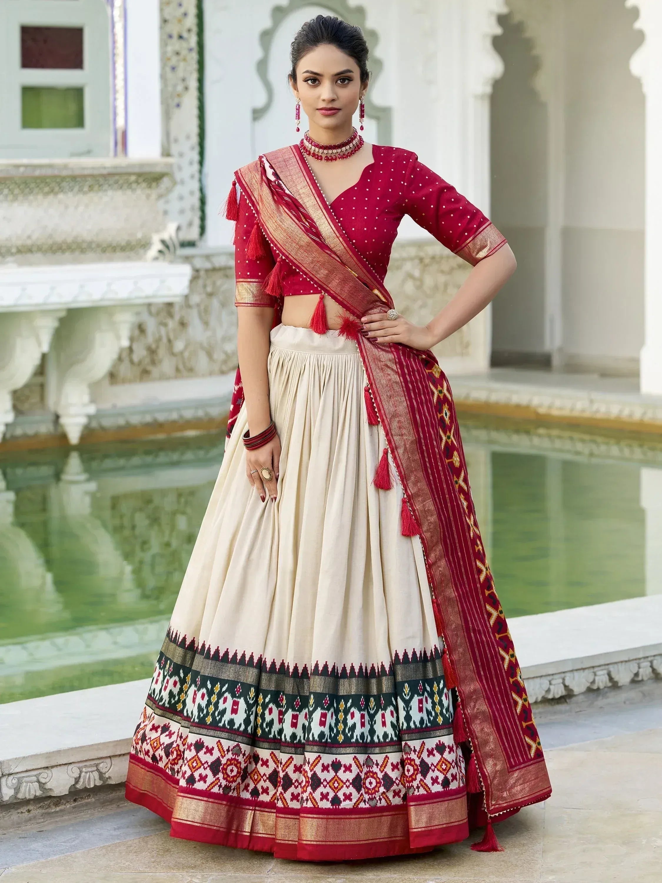Red and cream ethnic lehenga choli with embroidered dupatta, perfect for Indian weddings and festive occasions