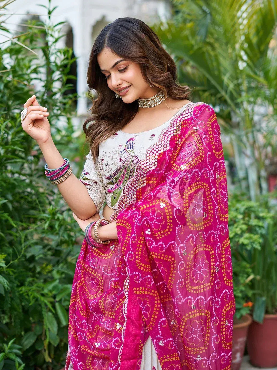 Woman in elegant Indian ethnic wear with peacock embroidery and pink dupatta, perfect for festive occasions