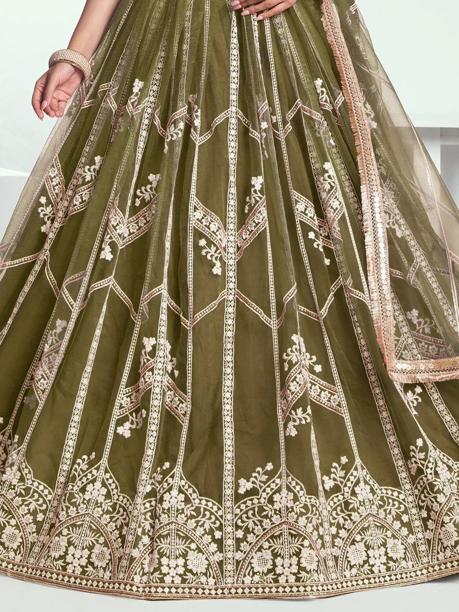Olive green lehenga with intricate white floral embroidery and gold detailing, perfect for Indian ethnic wear.