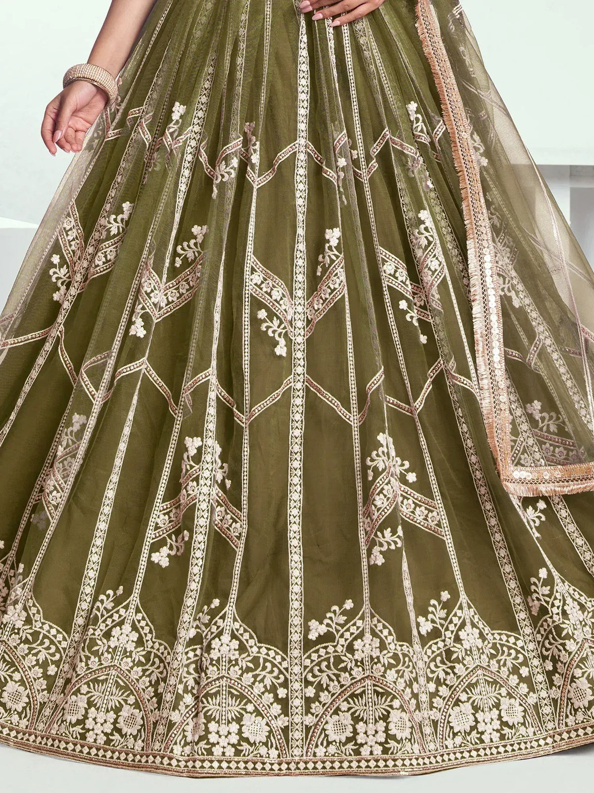 Olive green lehenga with intricate white floral embroidery and gold detailing, perfect for Indian ethnic wear.