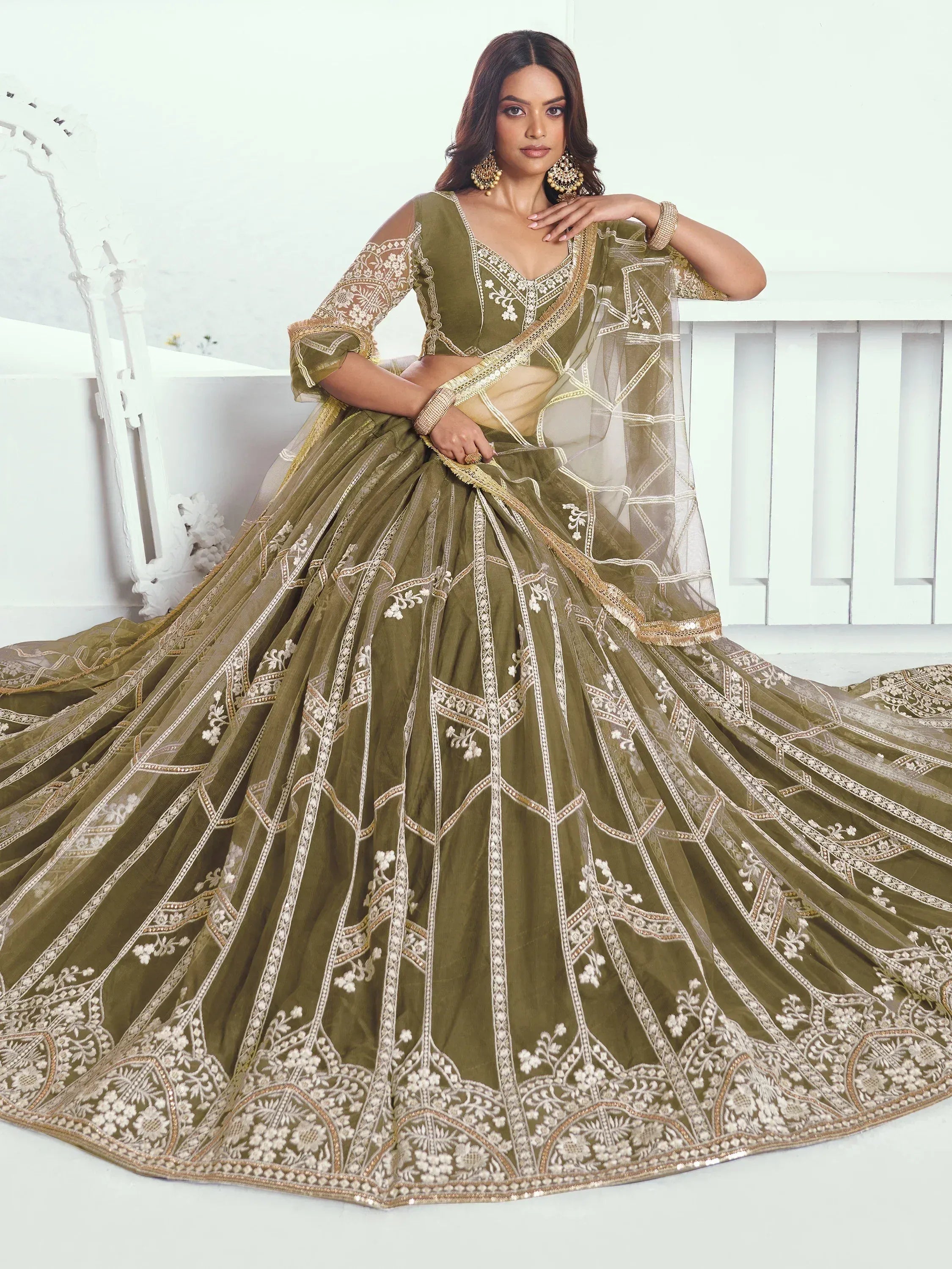 Olive green designer lehenga choli with intricate gold and white embroidery, perfect for weddings and festive occasions.
