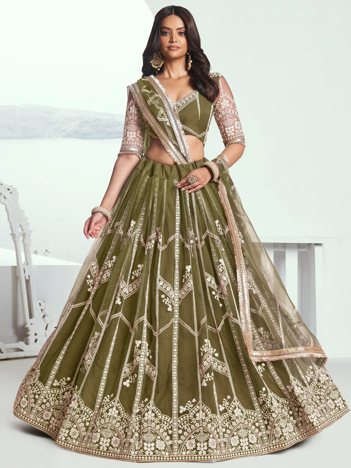 Olive green designer lehenga choli with intricate gold embroidery, perfect for Indian ethnic wear occasions.