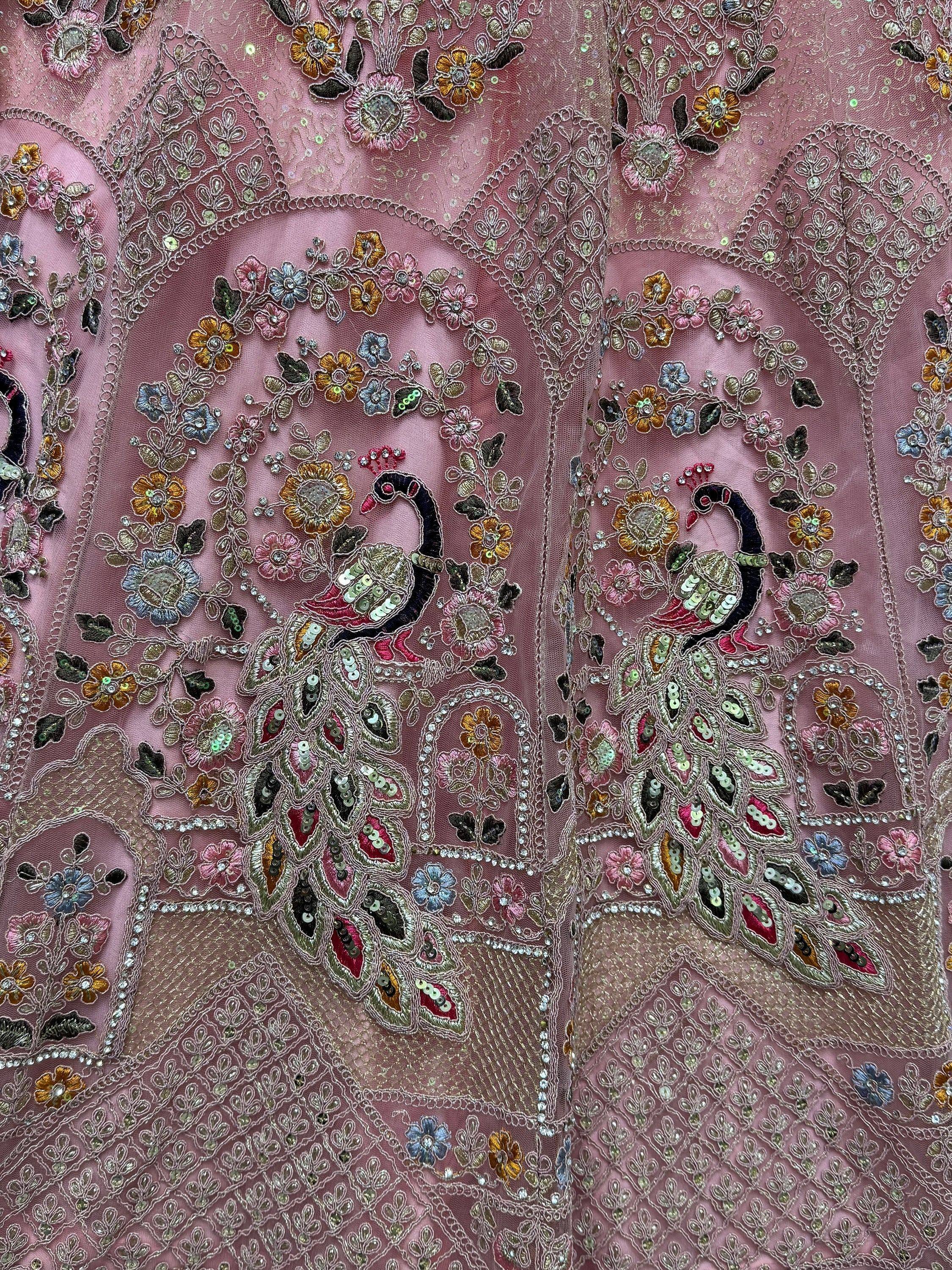 Pink ethnic gown with peacock embroidery, floral sequins, and intricate threadwork for festive occasions