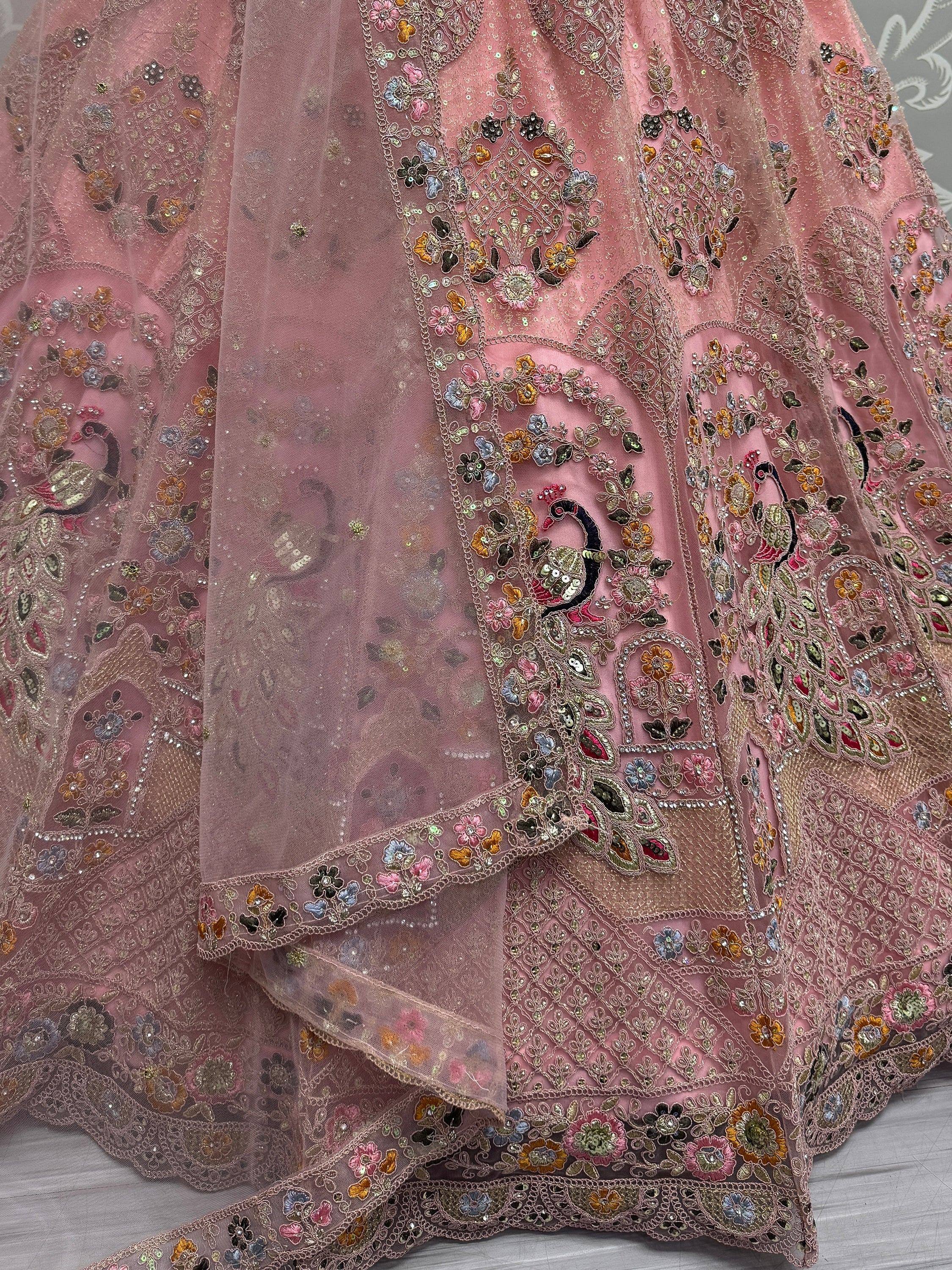Pink embroidered lehenga with floral and peacock motifs, sequins, and net overlay for Indian ethnic wear