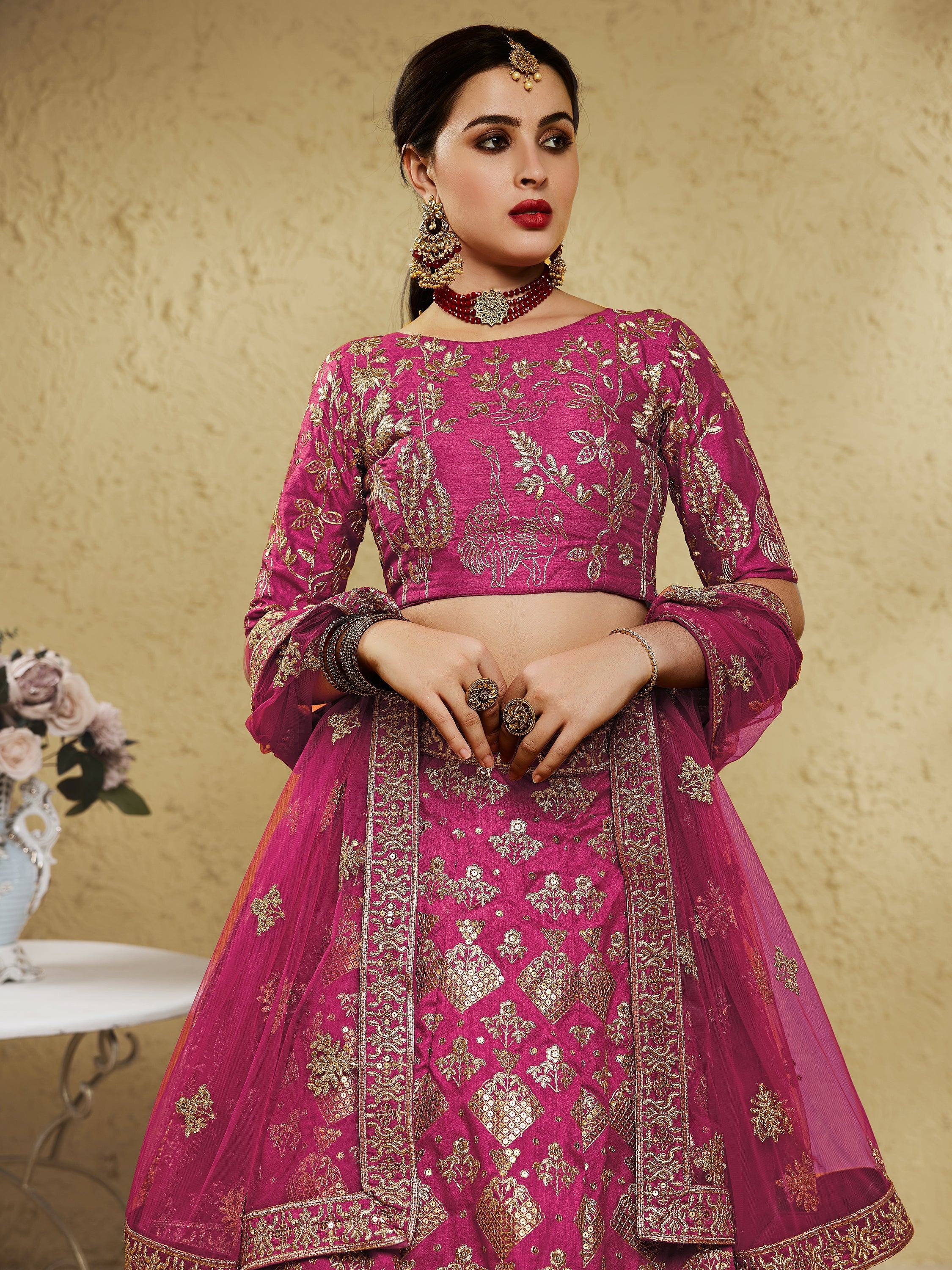 Pink embroidered lehenga choli with gold detailing, perfect for Indian weddings and festive occasions.